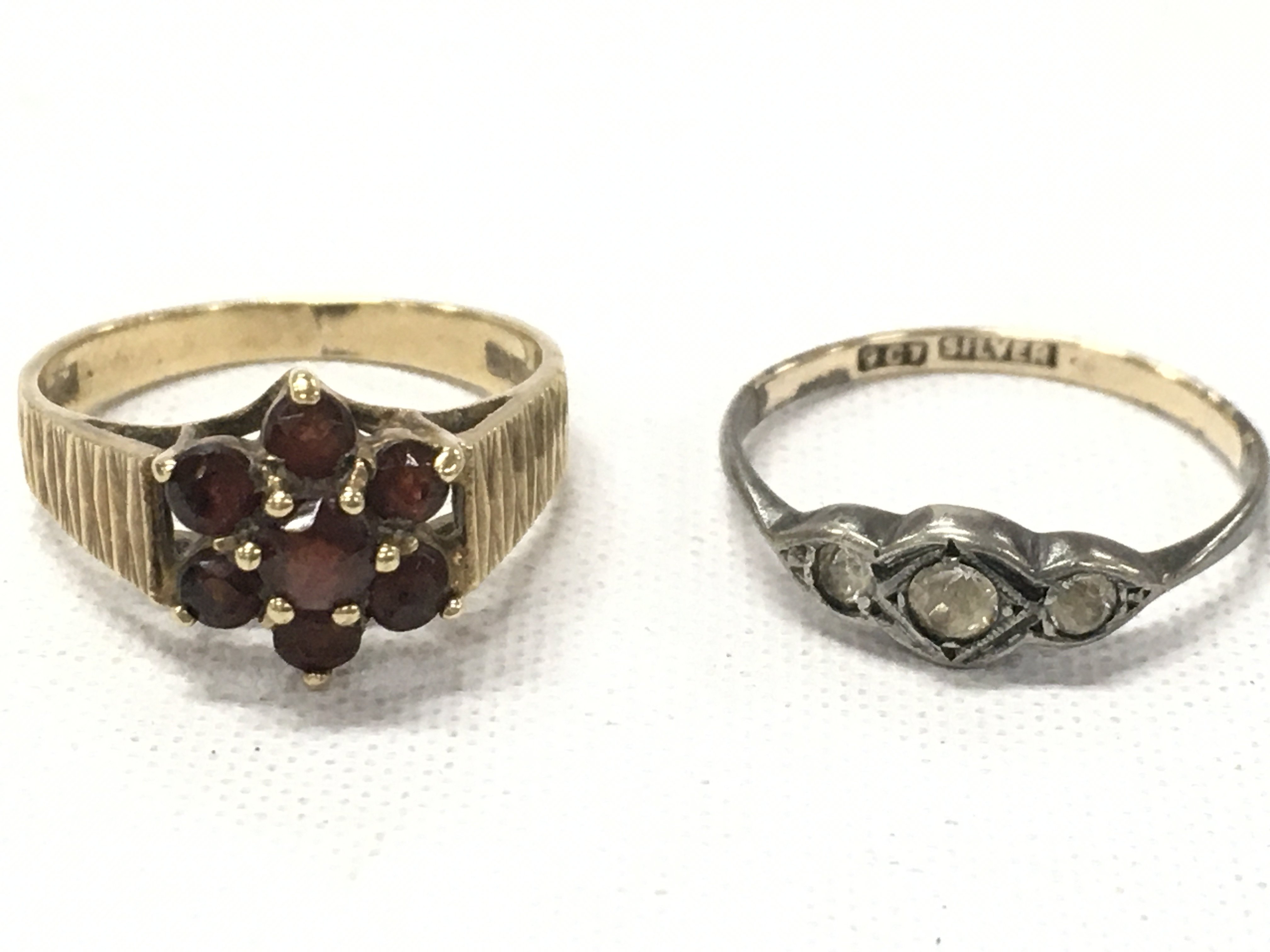A 9ct gold ruby set ring (2.6g total weight) and a silver ring. Postage category A