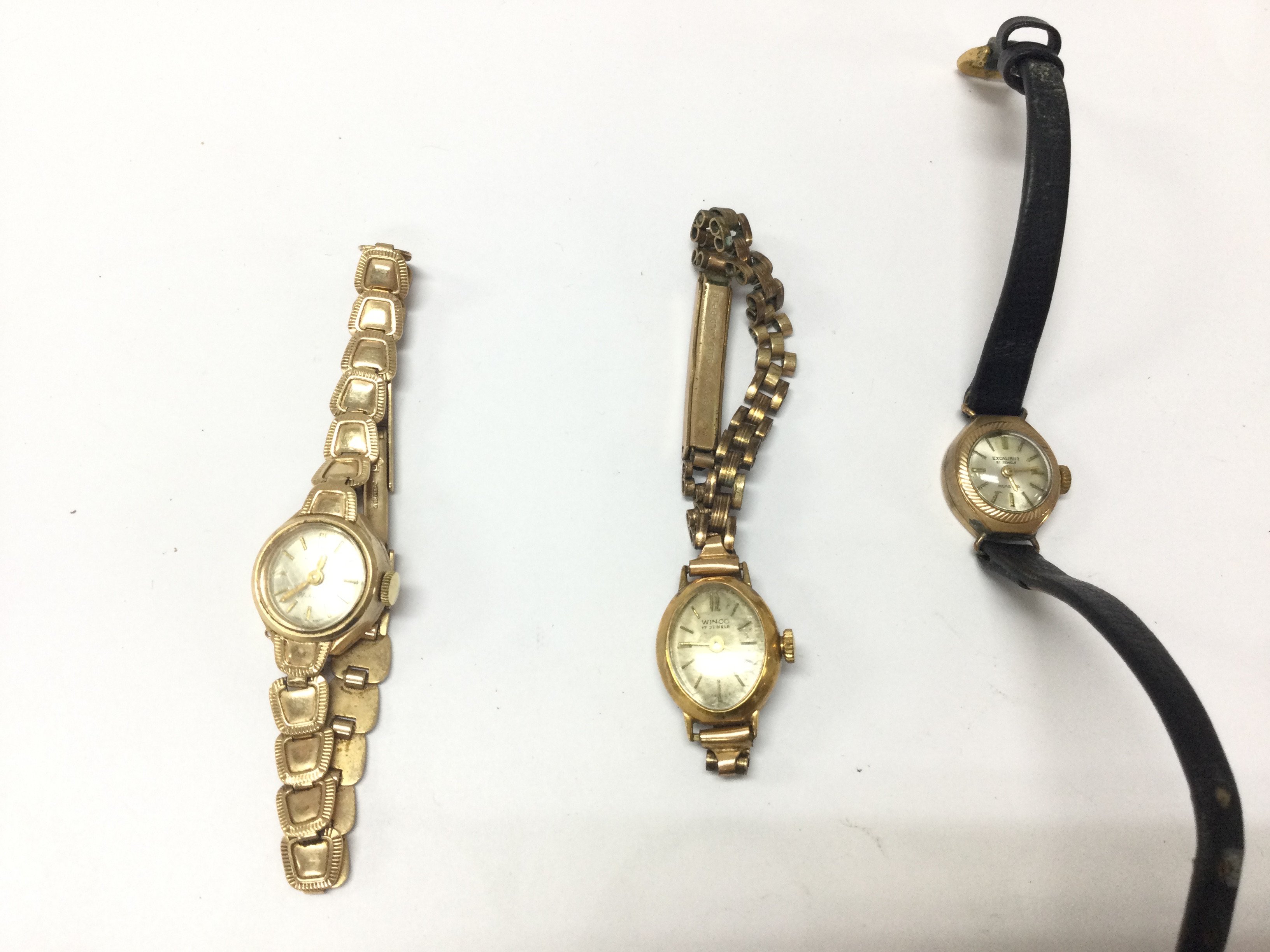 A 9ct gold watch 12.66g a rolled gold watch 12.29g and a 9ct gold cased watch 7.59g Postage B
