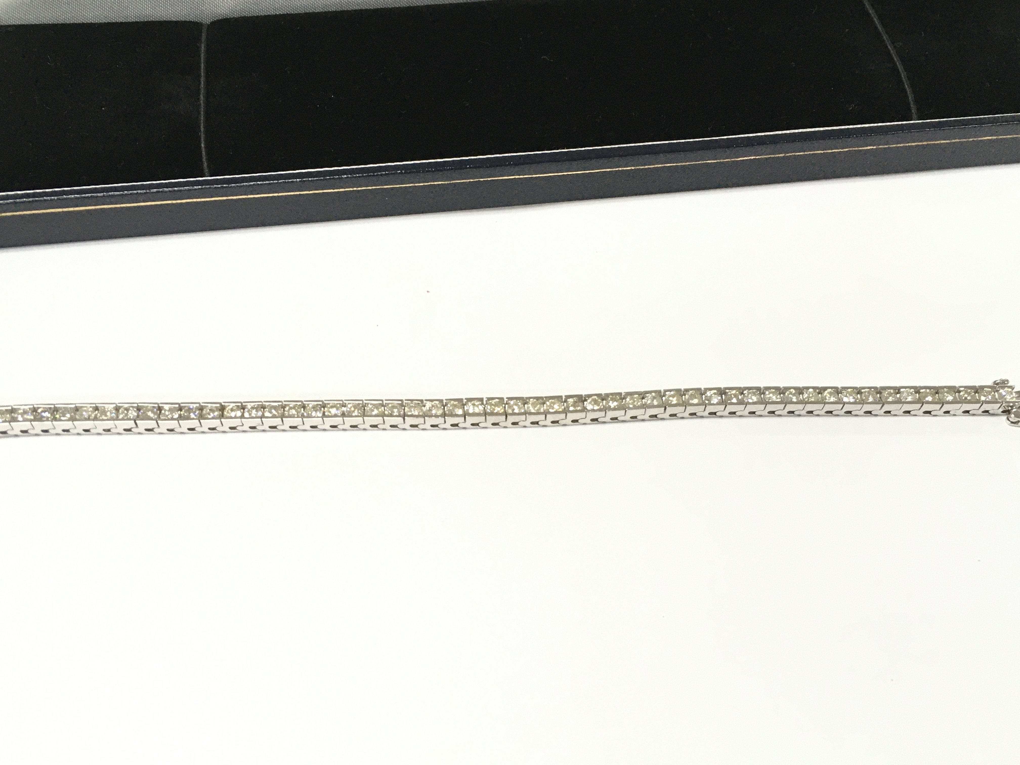 A 14ct white gold diamond line bracelet. Approximately 4.85ct diamonds total. Postage B