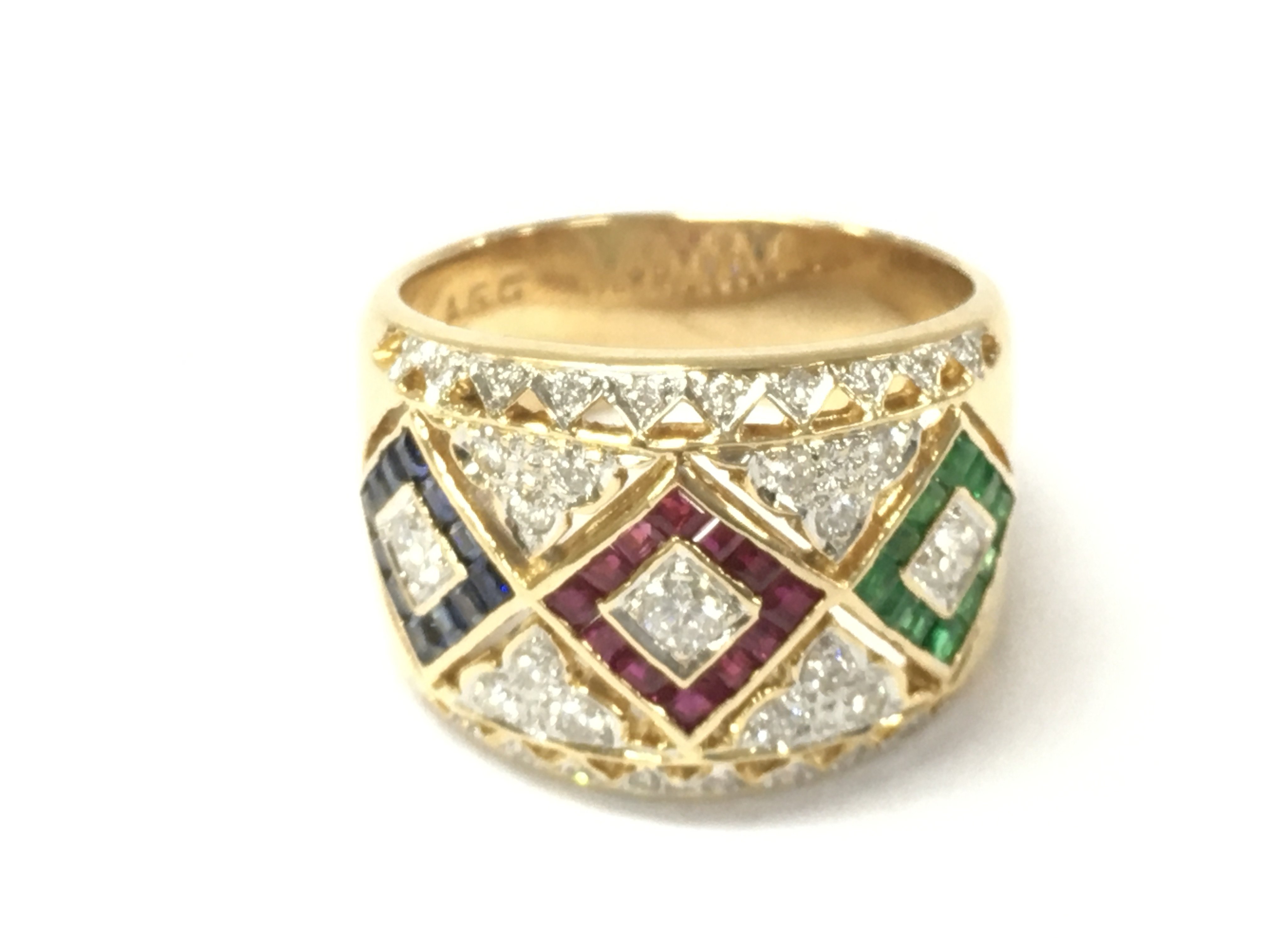 An unusual 18ct yellow gold tapered Harlequin style band set with calibre cut sapphire emeralds and rubies and diamonds. Diamonds 0.50ct rubies 0.18ct sapphire 0.18ct and emeralds 0.18ct all approx. Size N 1/2