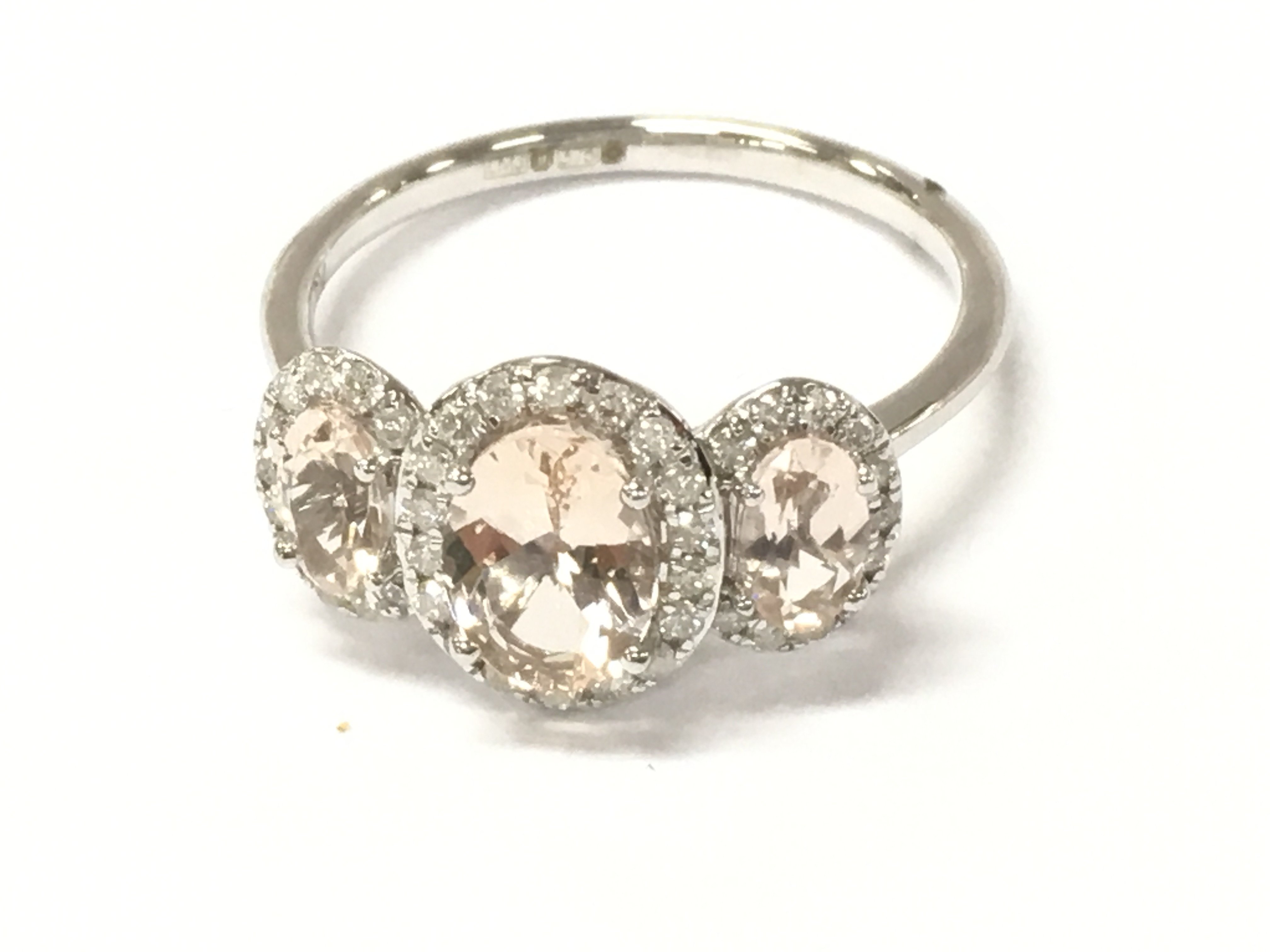 A 9ct rose gold morganite and diamond triple cluster ring. Three graduated oval morganites 1.17ct and diamonds 0.23ct approx. Size L 1/2 Postage A