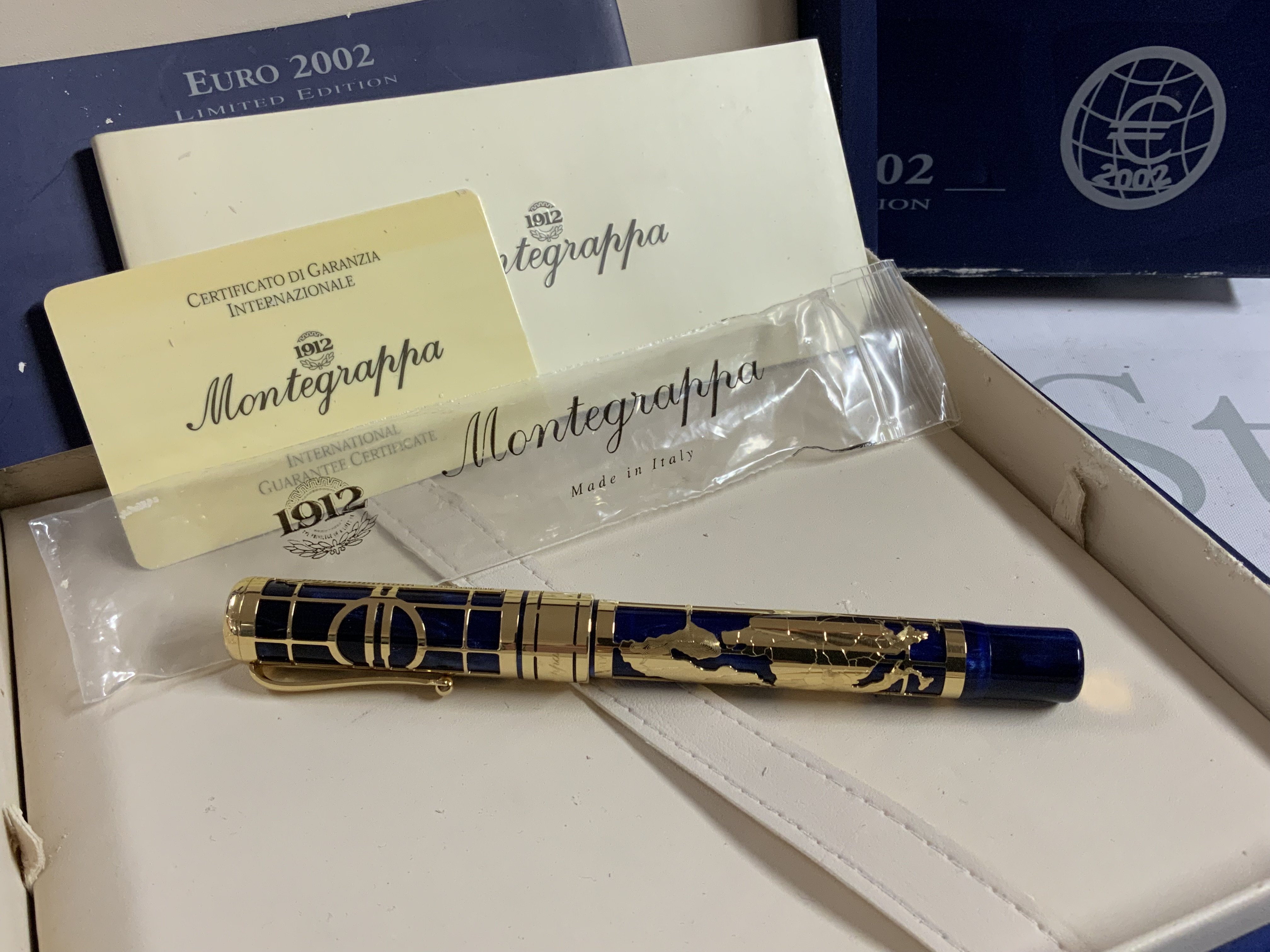 A 2002 euro Montegrappa 18k gold and blue enamel roller ball Ben with box and papers. The map of Europe accent around the pen is also hallmarked 18k gold. Limited 80/100