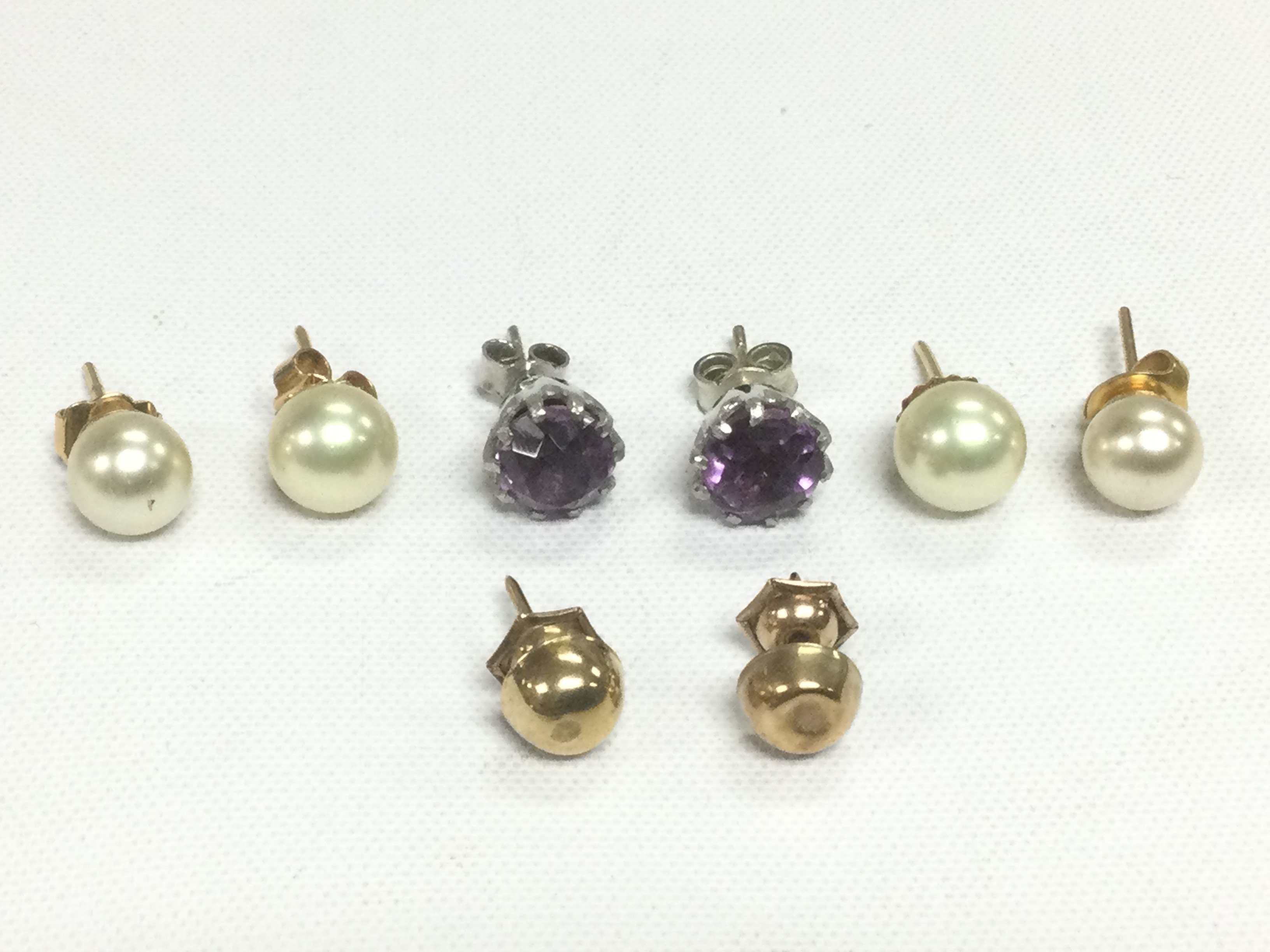 Four pairs of earrings comprising gold, pearl and amethyst examples. Shipping category A.