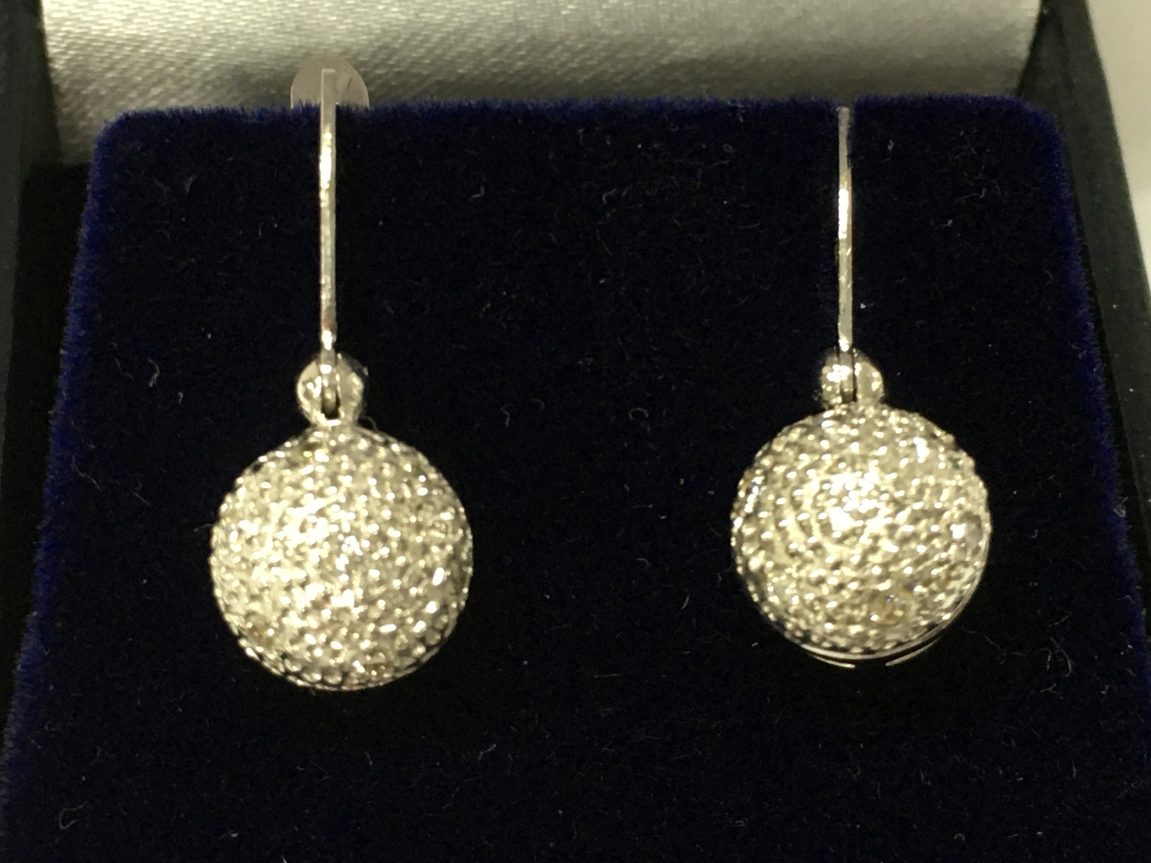 A pair of 18ct white gold droplet earrings set with diamond ball cluster with omega fastenings. Diamonds 0.18ct approx.