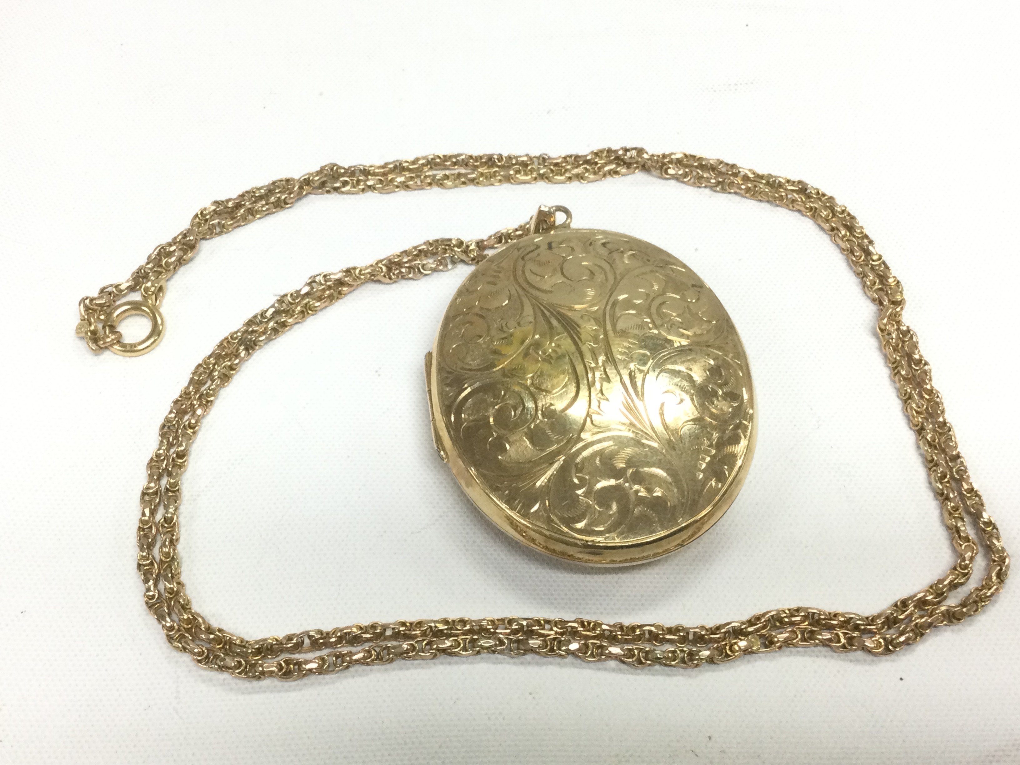 A 9ct gold pendant and chain, approx length 4.5cm and approx 26.9g. Shipping category A.