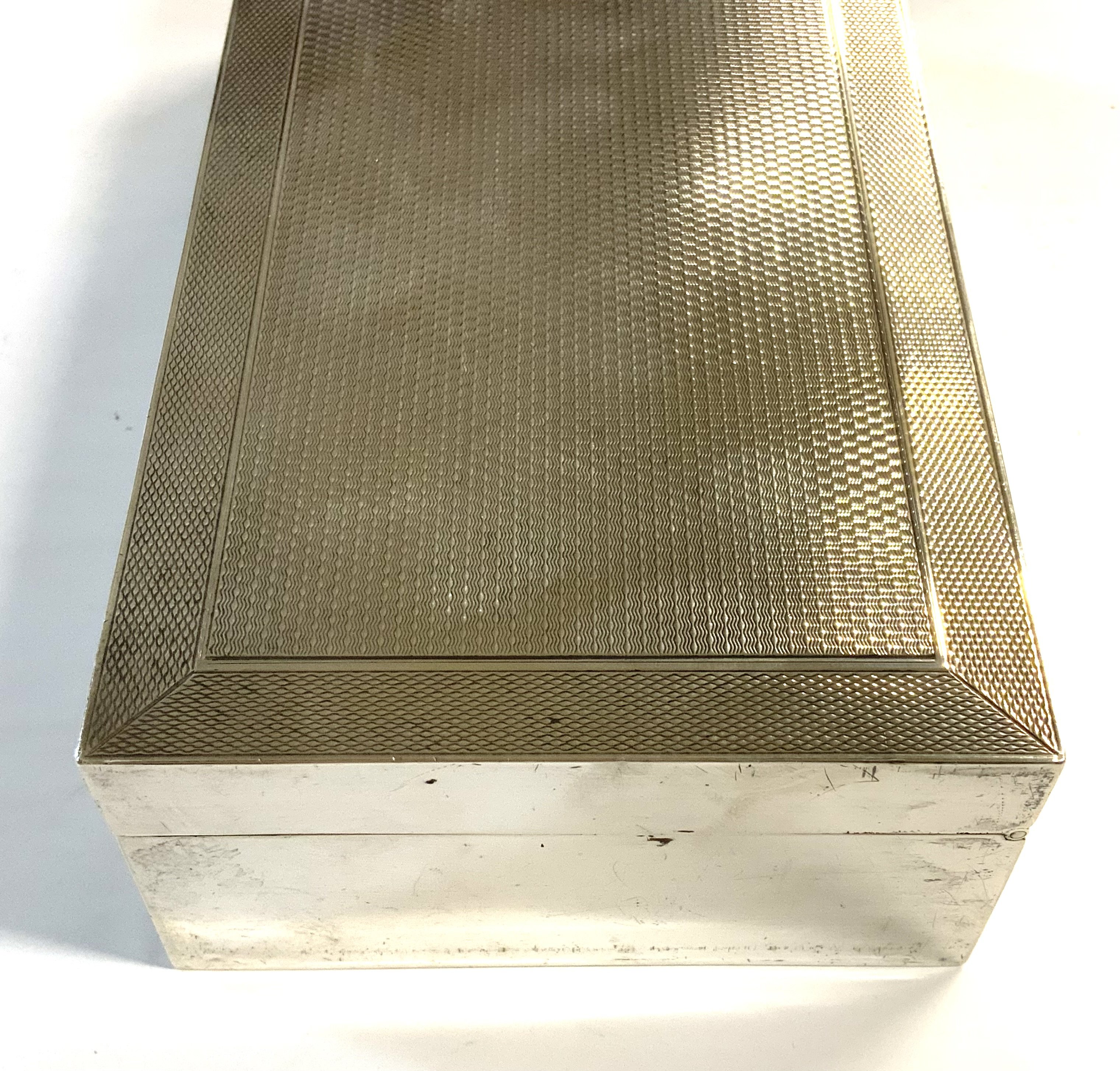 A hallmarked silver cigarette box with engine turned decoration to cover, marks for Mappin & Webb, London 1931.