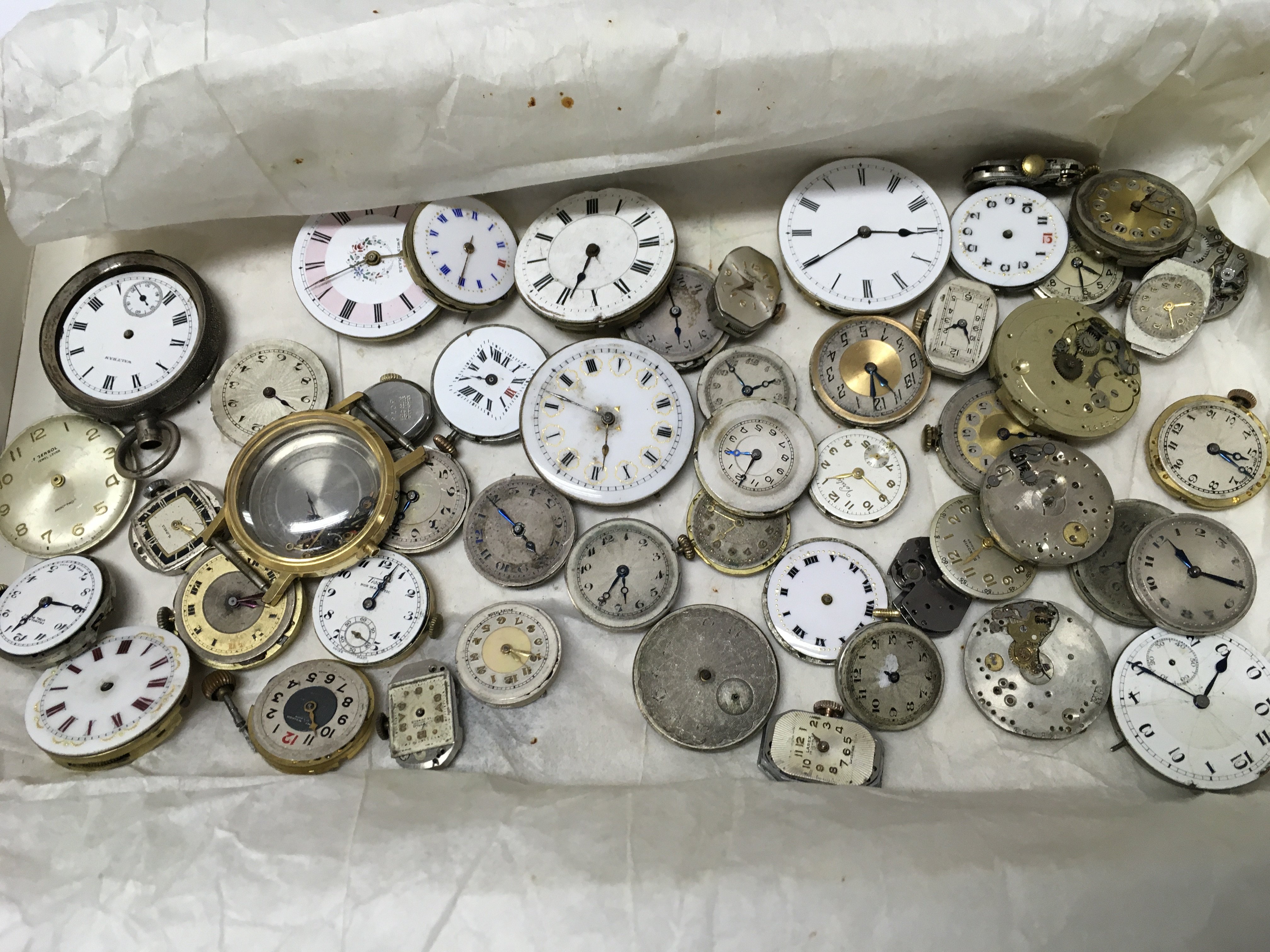 A mixed collection of vintage watch movements for spares . Postage cat b
