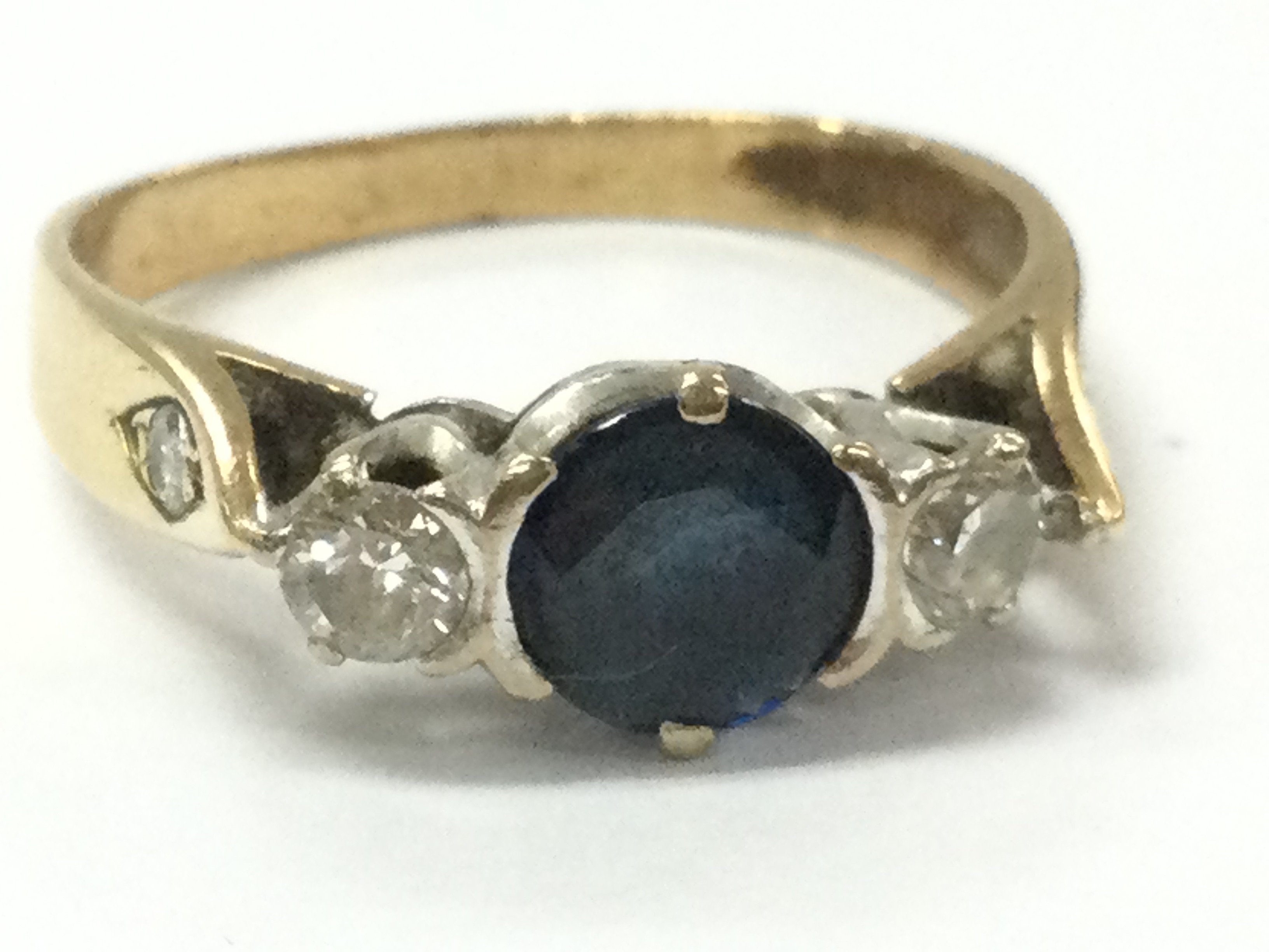 A sapphire stone 9ct ring set with two diamonds, 4g total weight. Postage category A