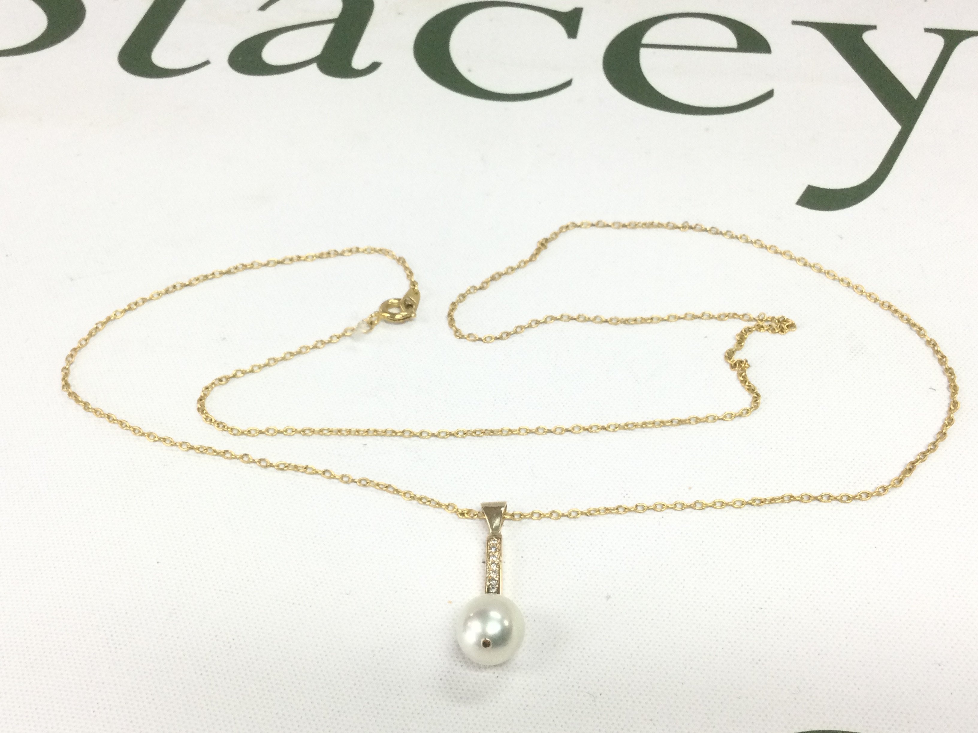 An 18ct gold diamond and pearl set pendant on a chain (not gold). Shipping category A.
