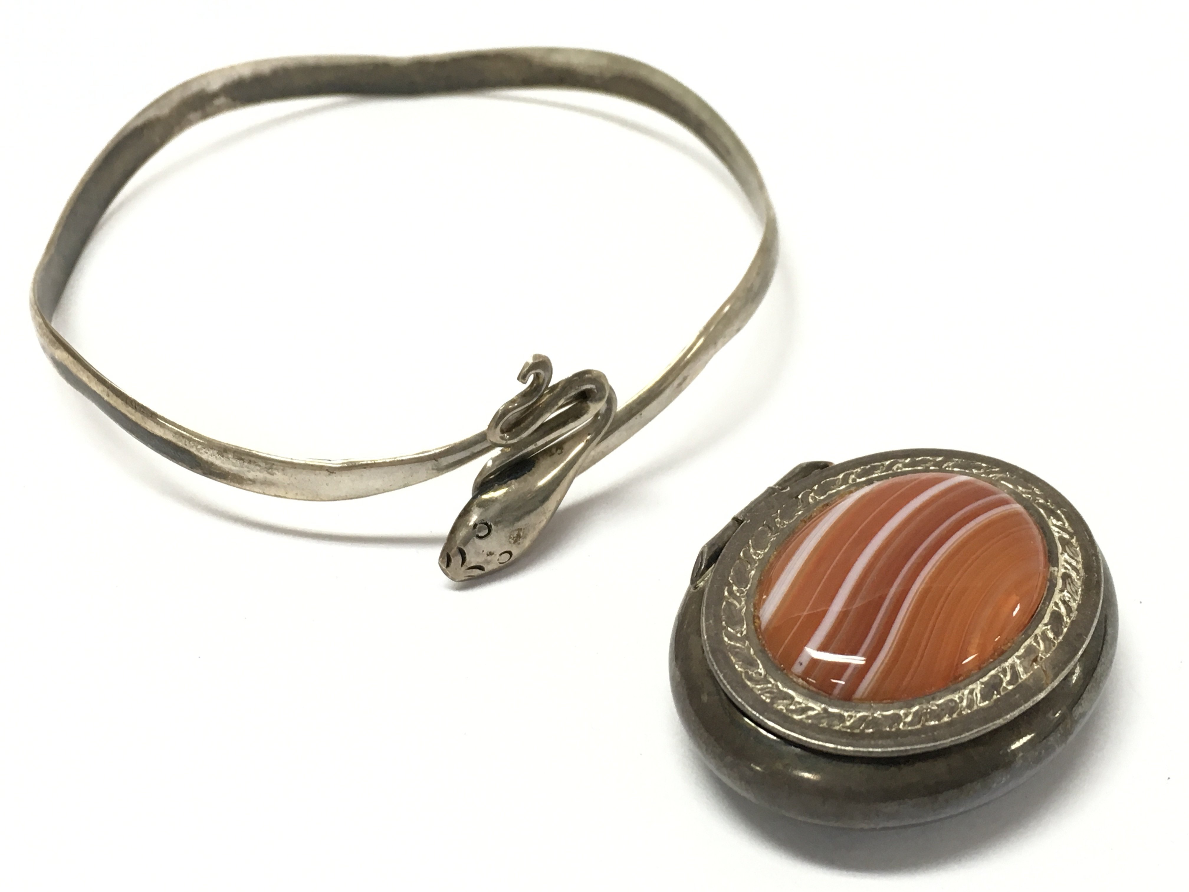 A silver pill box and a silver snake bangle. Postage catA