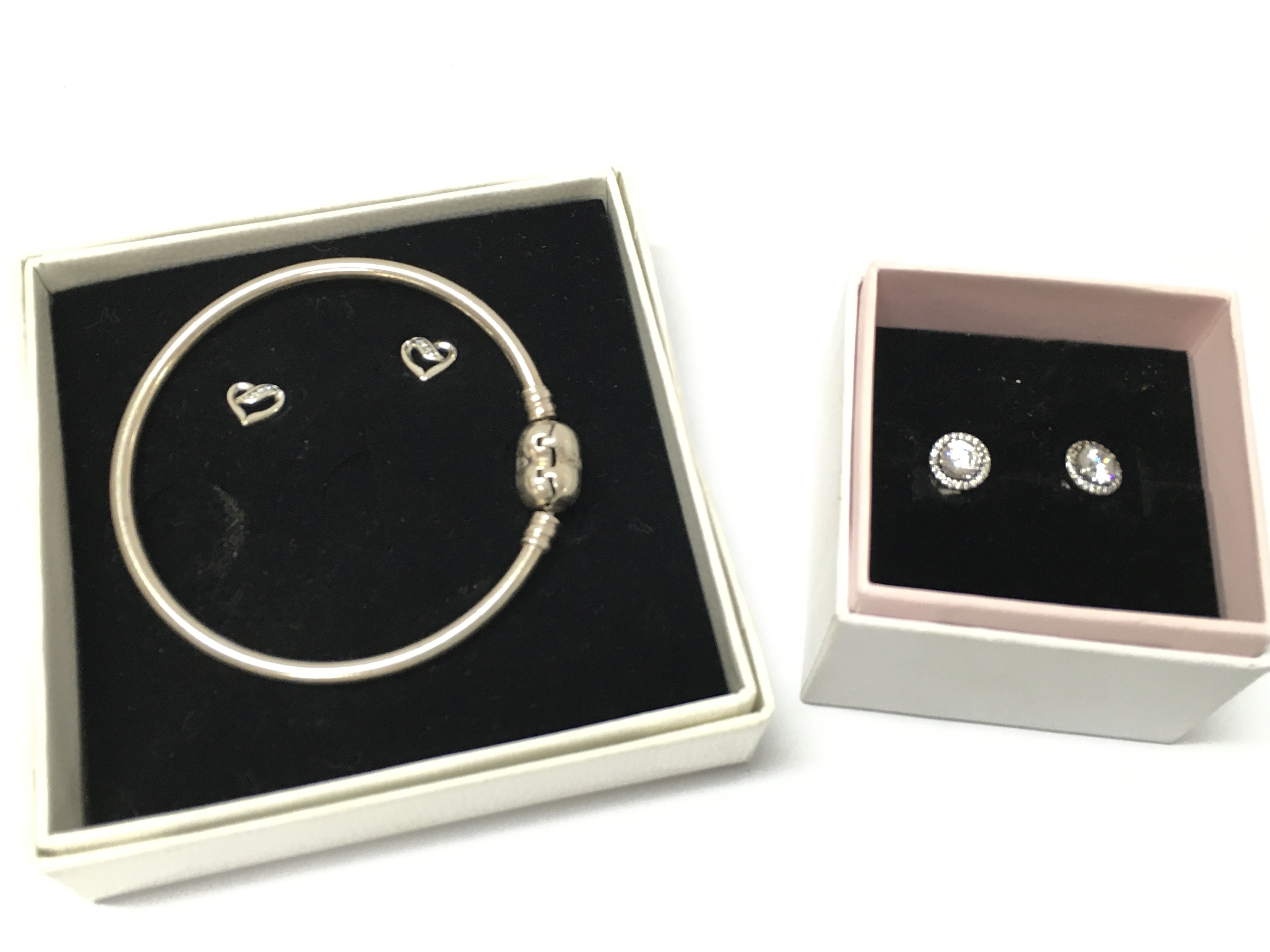 Boxed silver Pandora jewellery including earrings and a bracelet. Postage category B