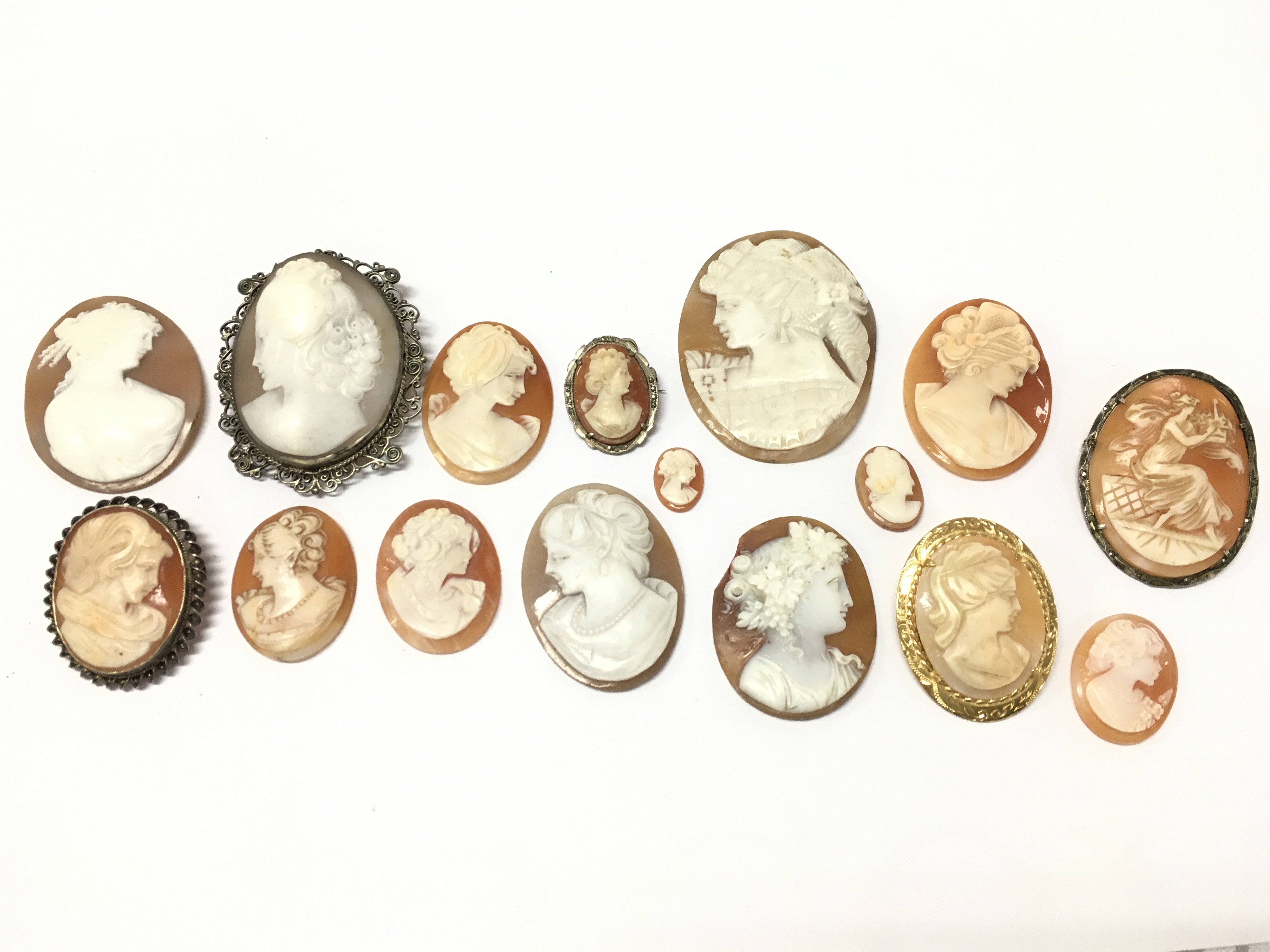 A collection of cameos, some silver / yellow metal mounted