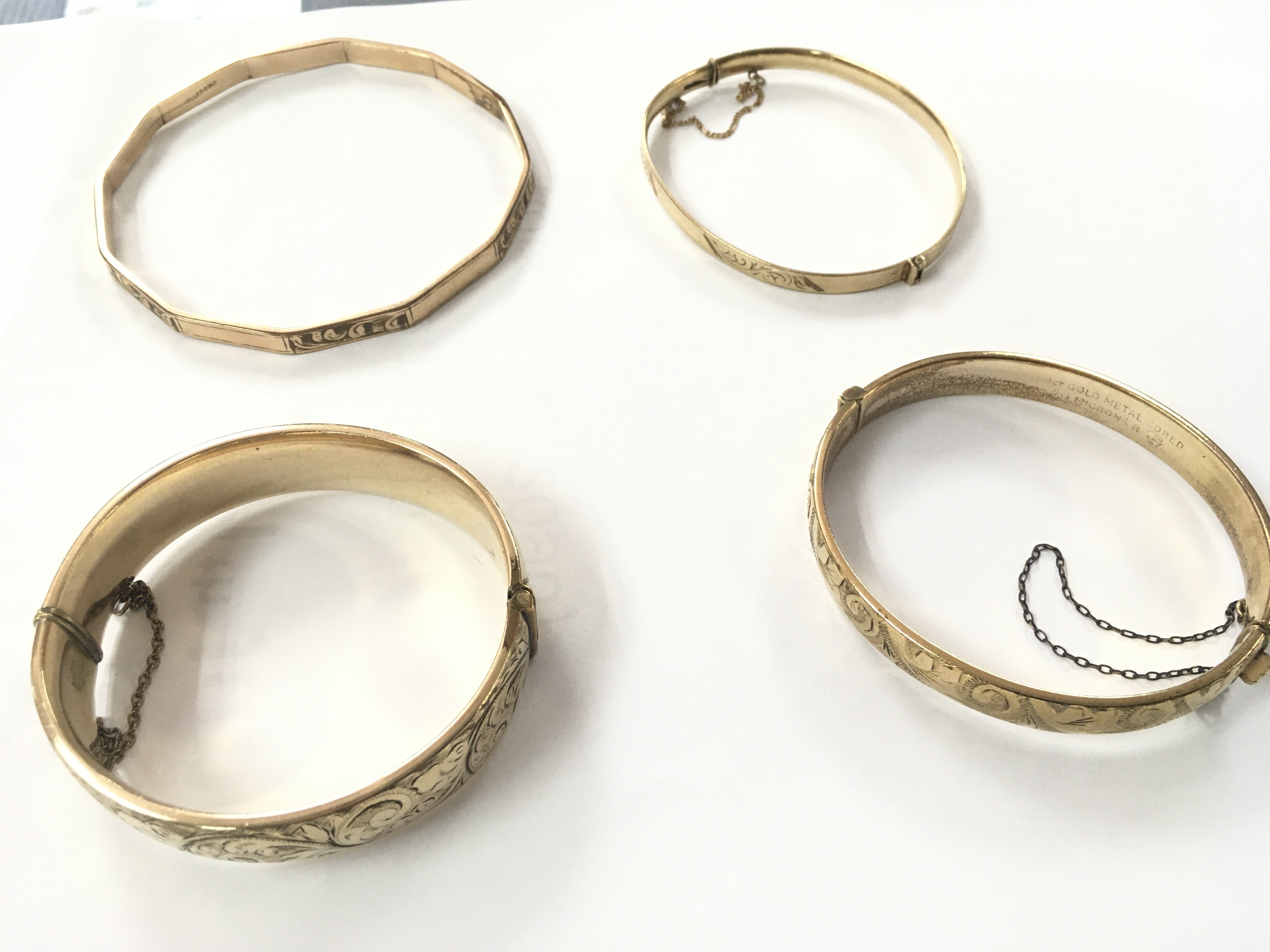 Four rolled gold bangles. Shipping category A.