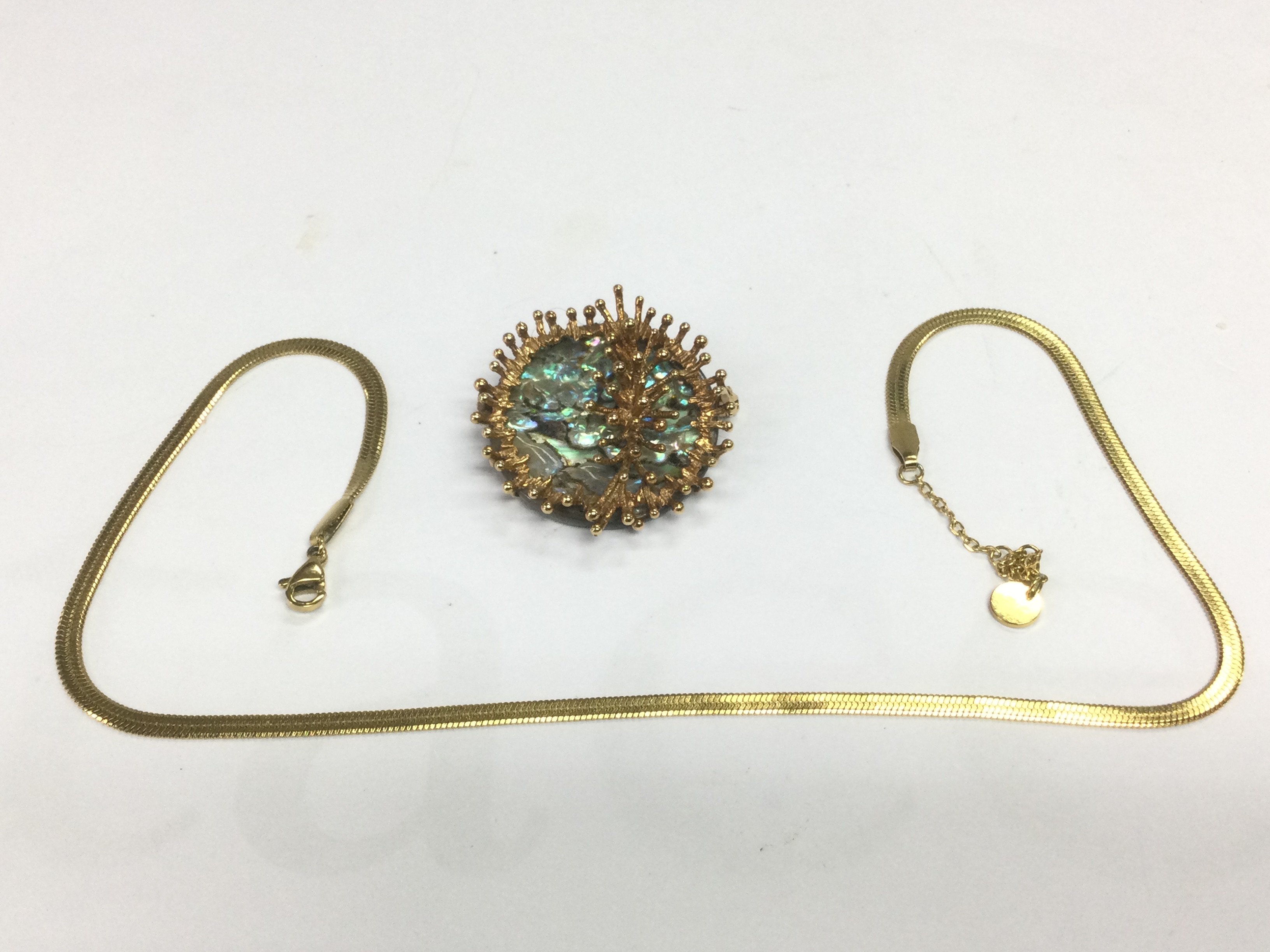 A 9ct gold mounted brooch and a gold chain, total approx weight 16g. Shipping category A.