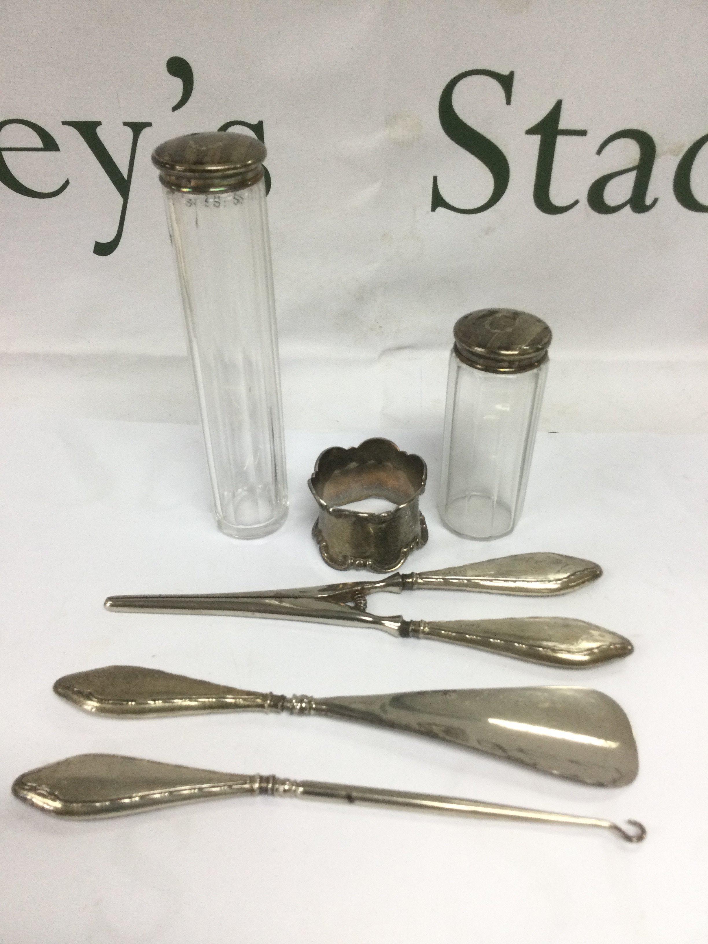 Two silver topped scent bottles, silver napkin ring, silver handled button hook etc. Shipping category D.