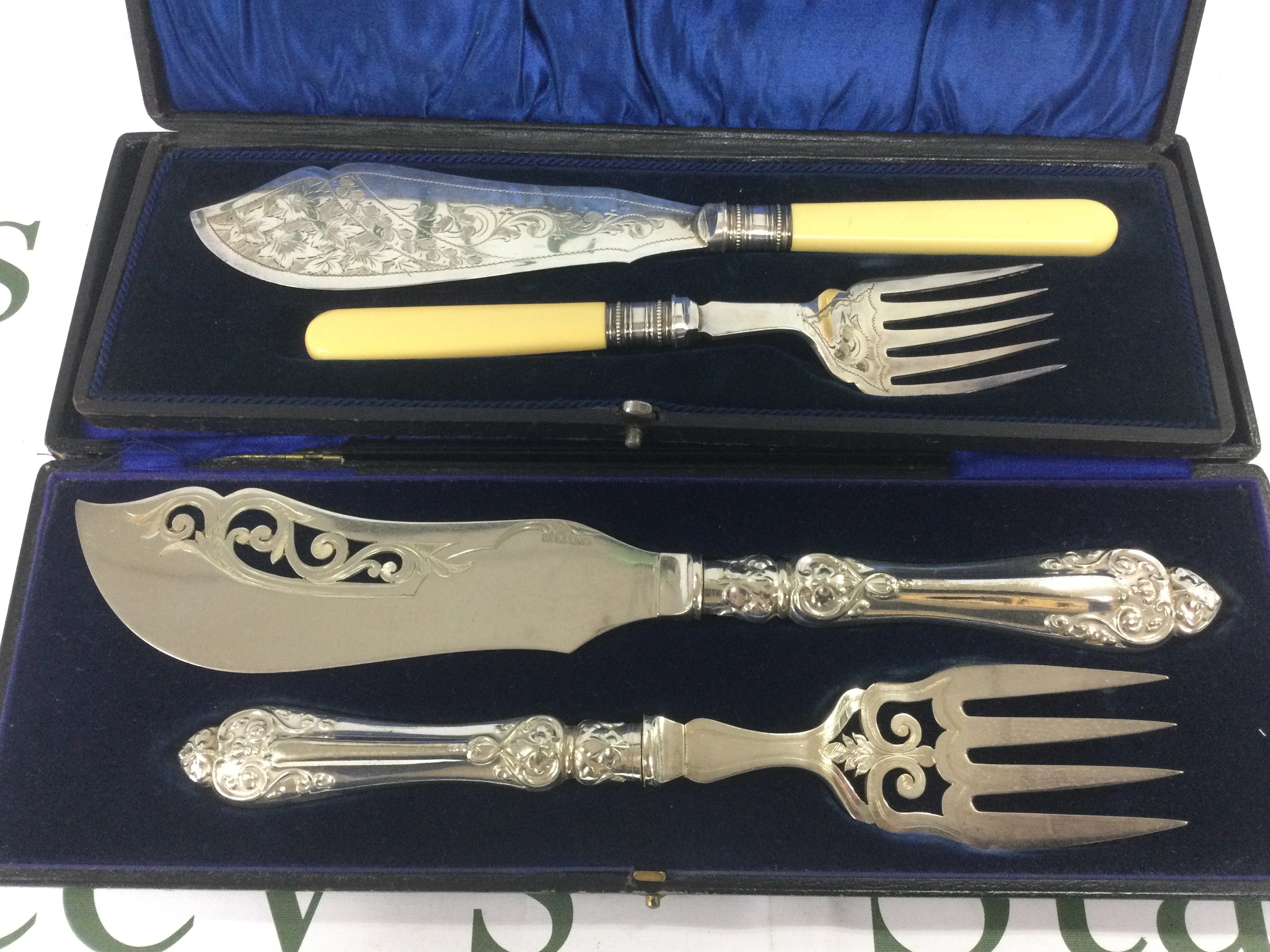 A cased silver fish slice and server set together with a silver plated set. Shipping category B.