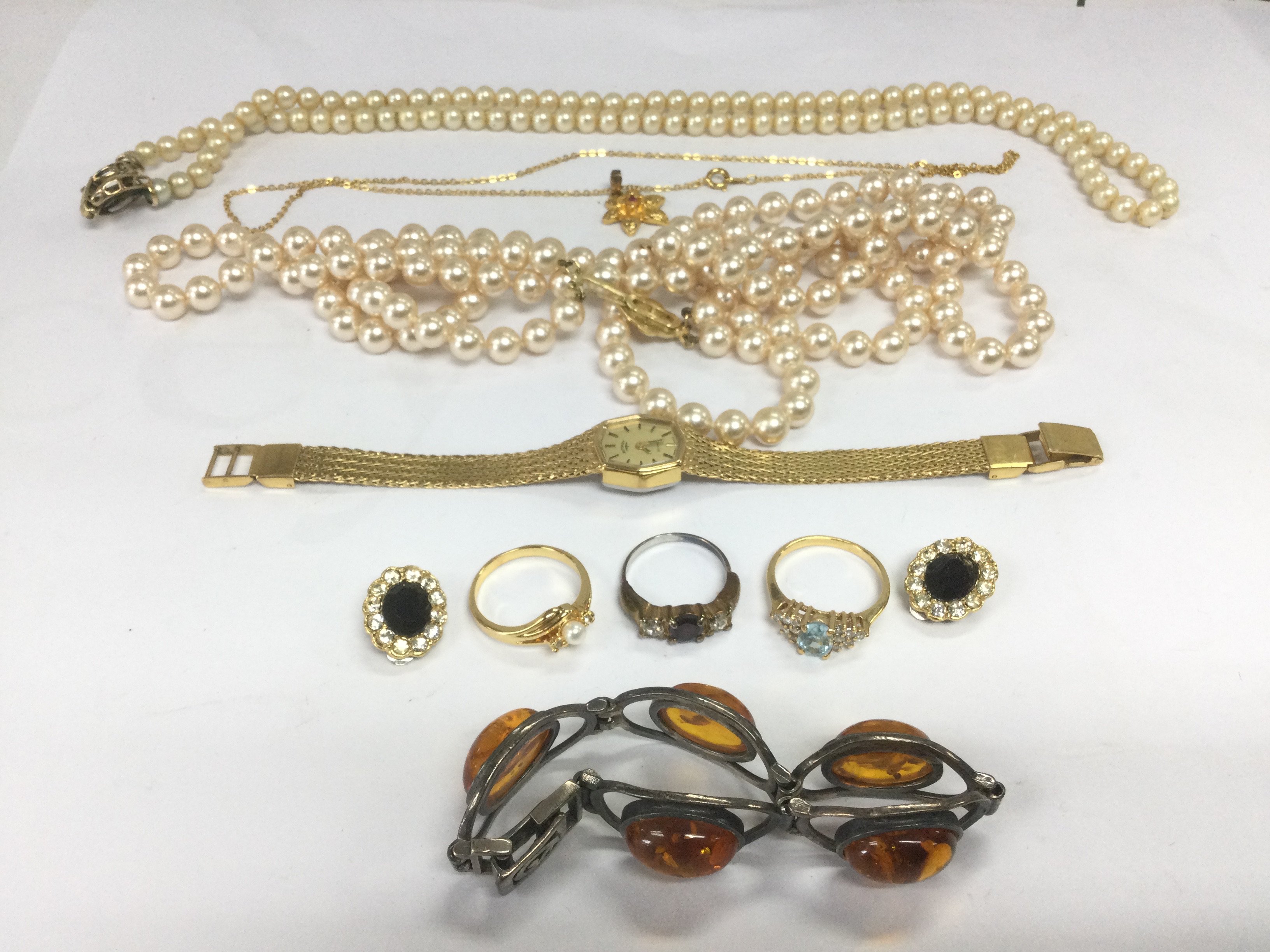 A collection of costume jewellery including a silver and amber bracelet, simulated pearls etc. Shipping category B.