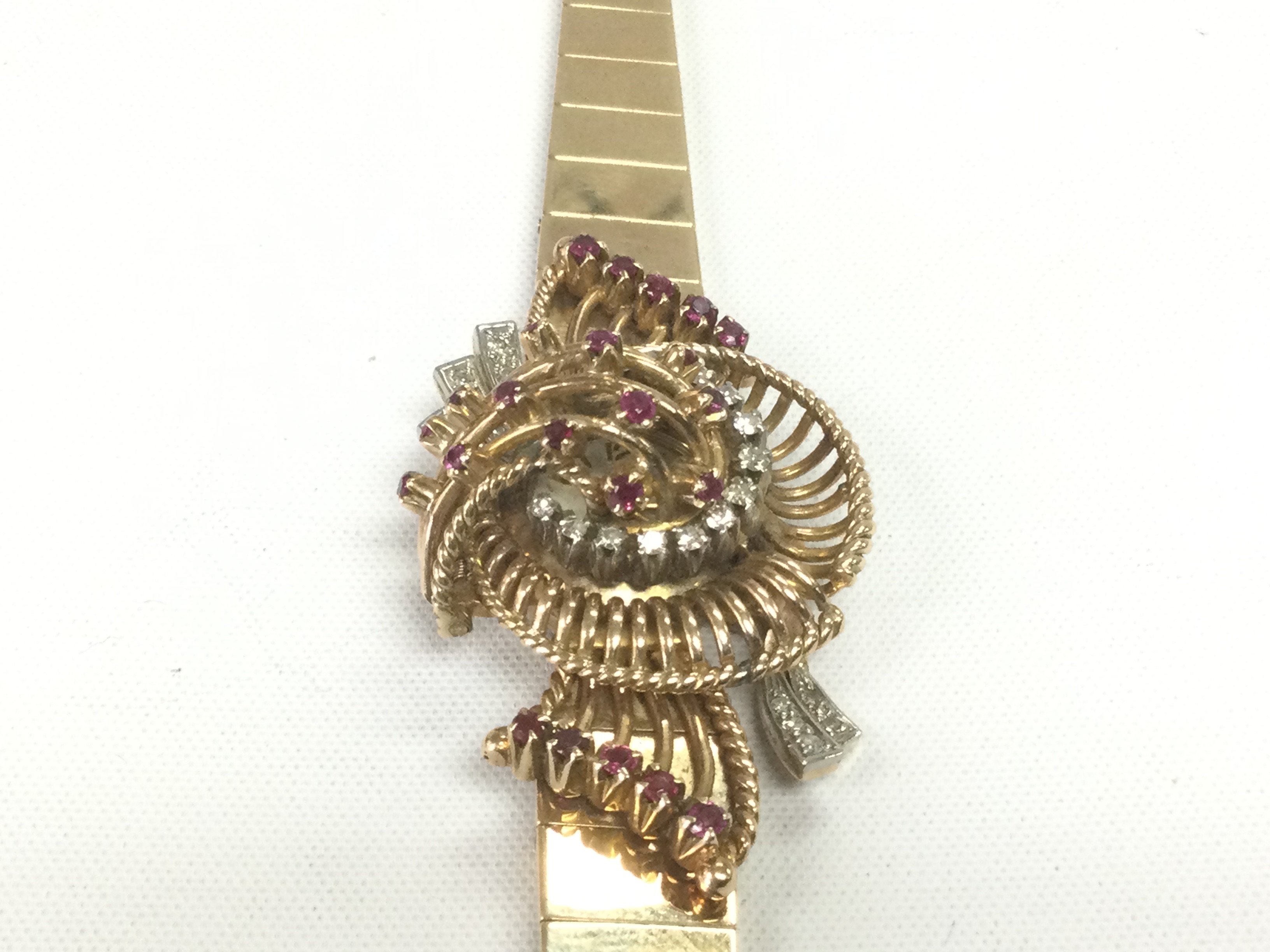 A 9ct gold Jaeger Le Coultre ladies watch lavishly decorated with diamknds and rubies, approx 44.2g. Shipping category A.