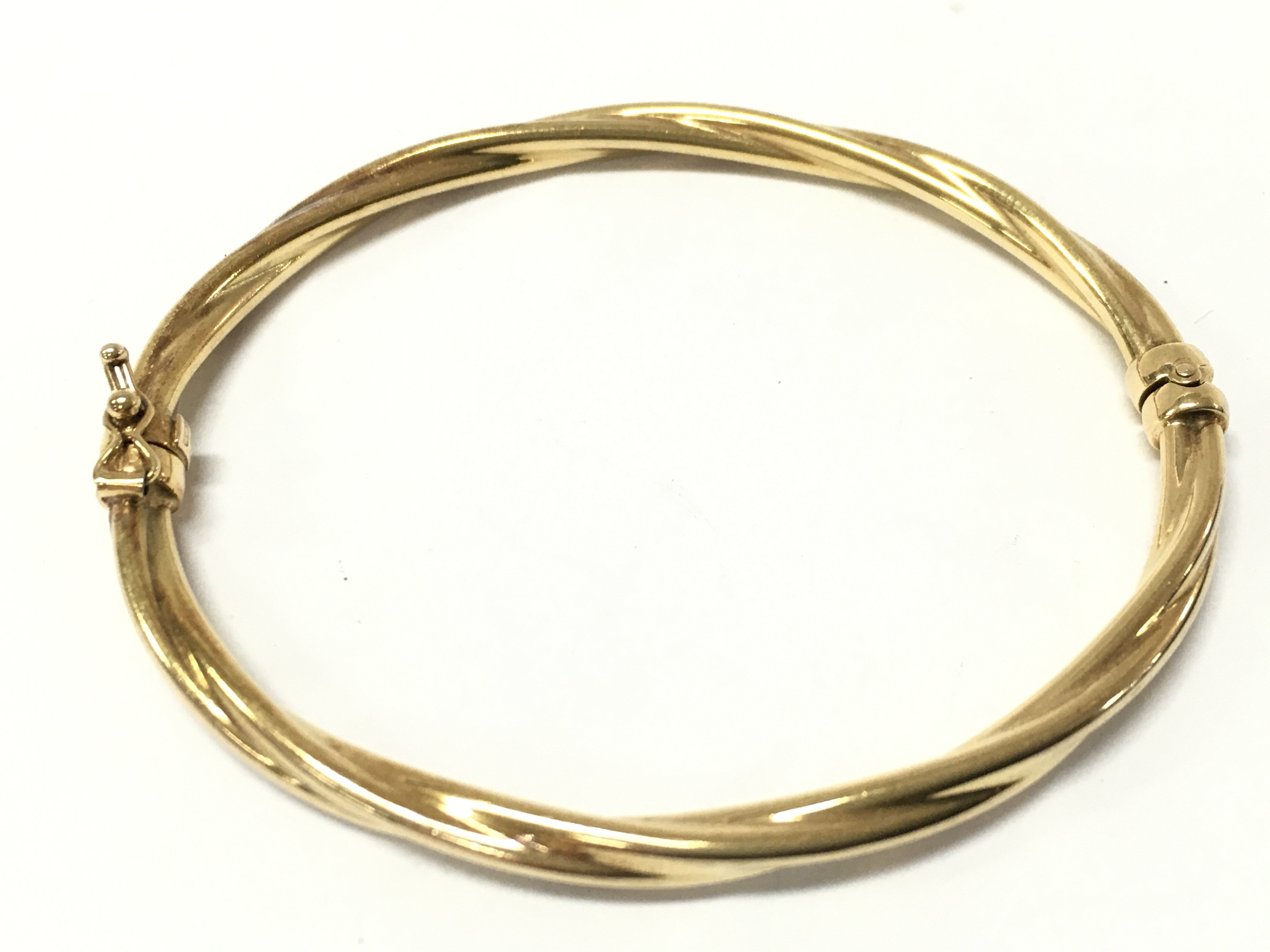 A 9ct gold bangle, 5.4g total weight. postage category A