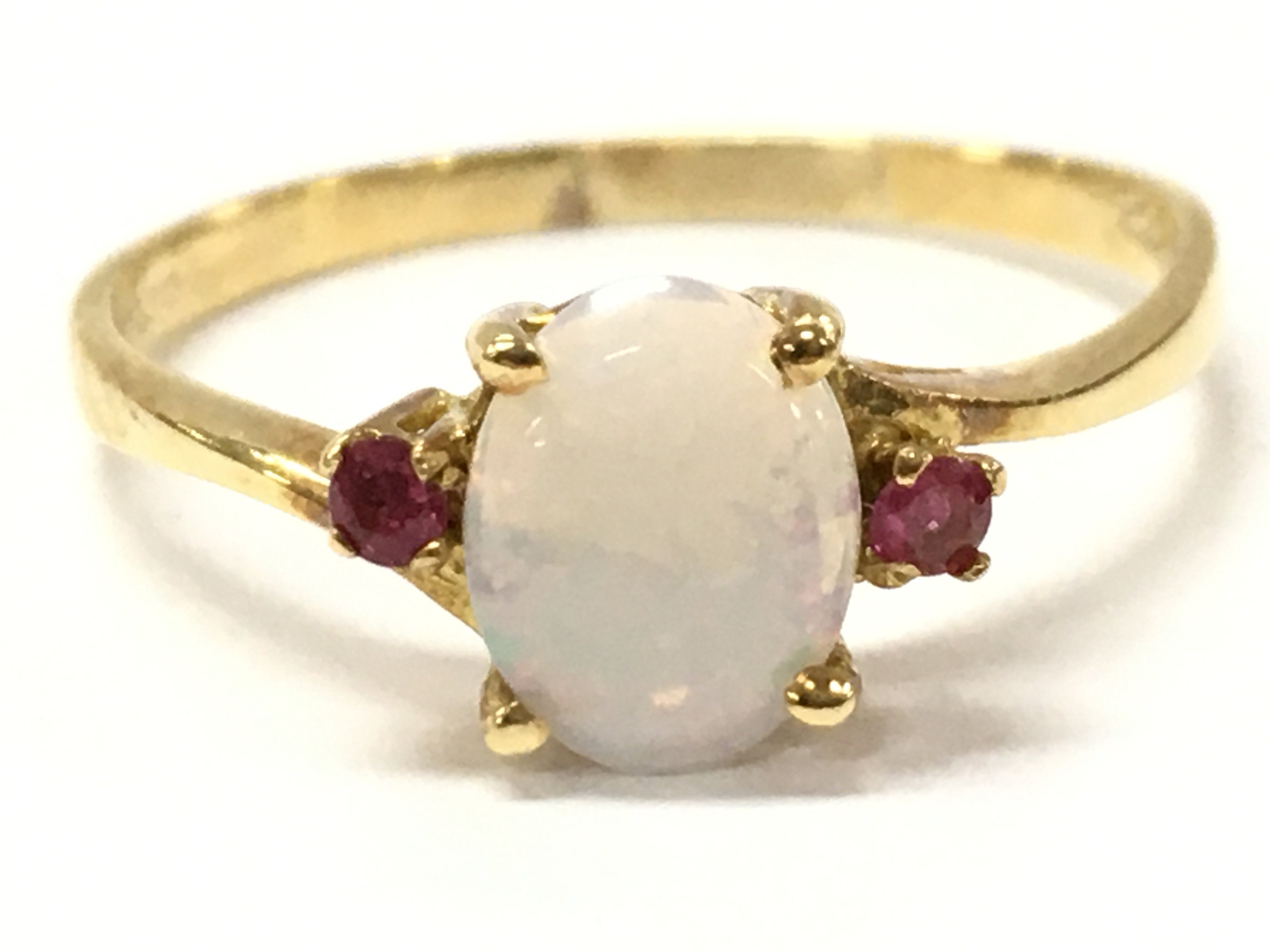 An 18ct ruby and opal ring , 2.4g total weight. Size S. Postage category A
