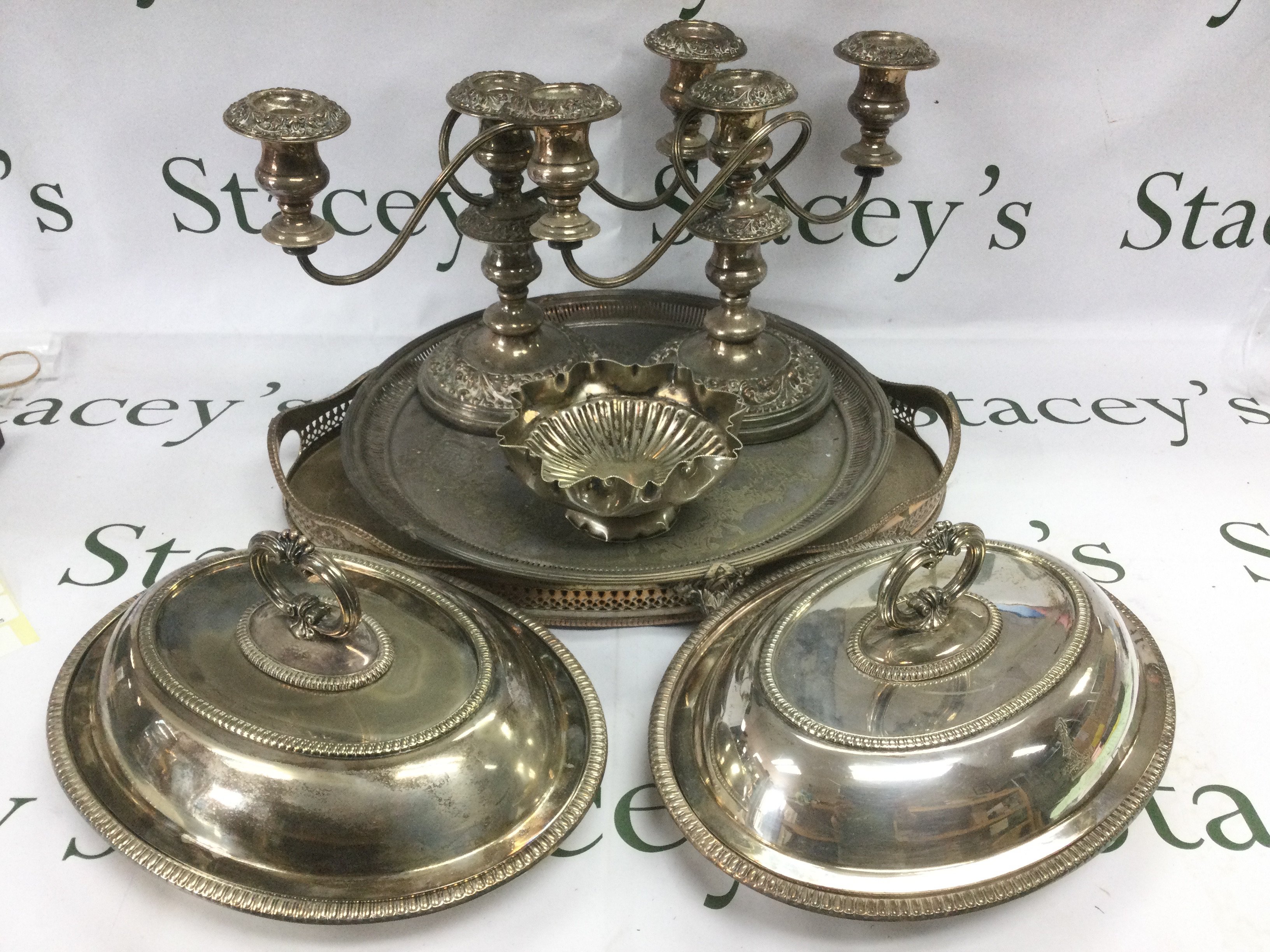A collection of silver plated items comprising a tray, candelabra etc. Shipping category D.