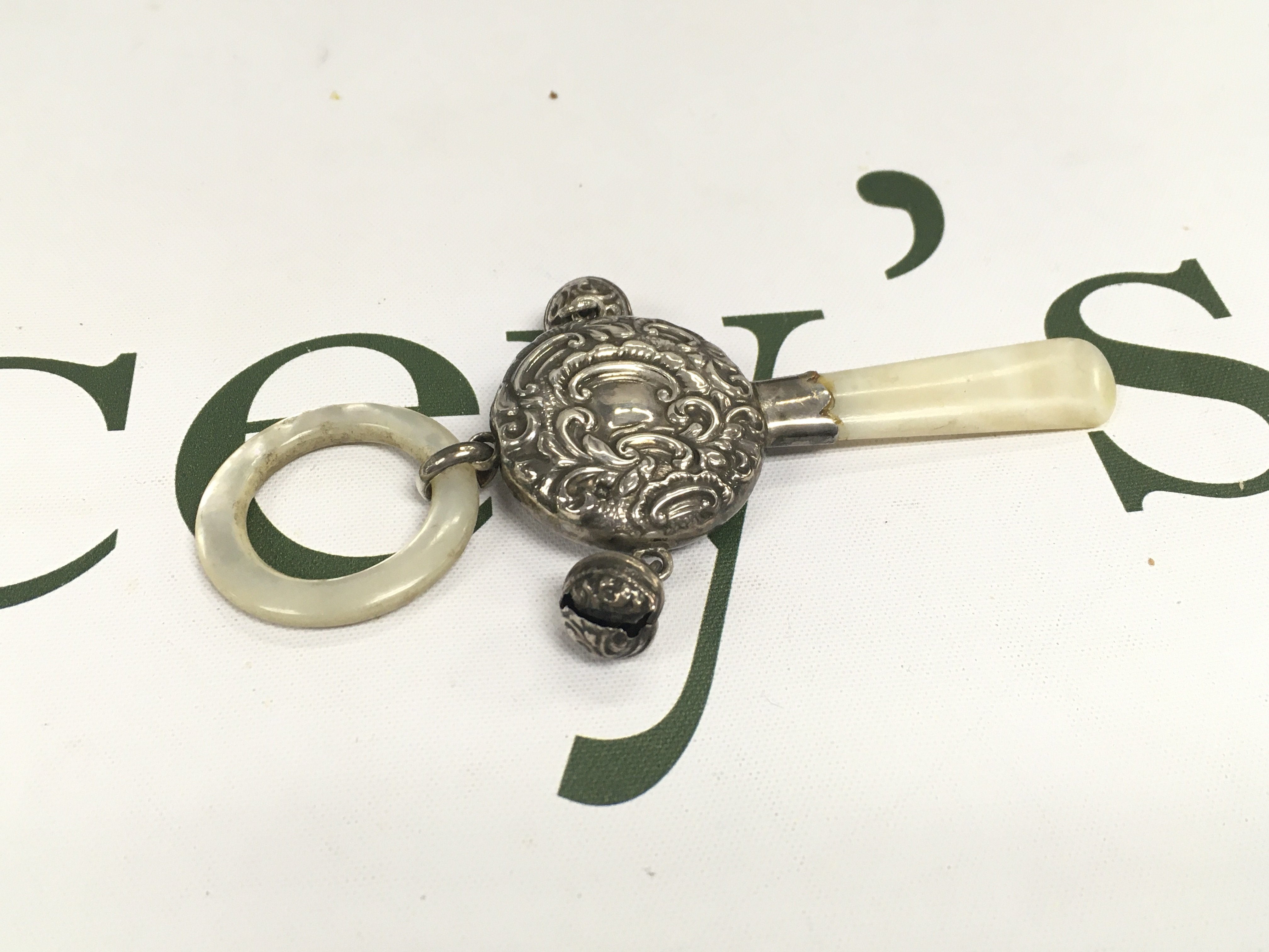 A silver childs rattle.