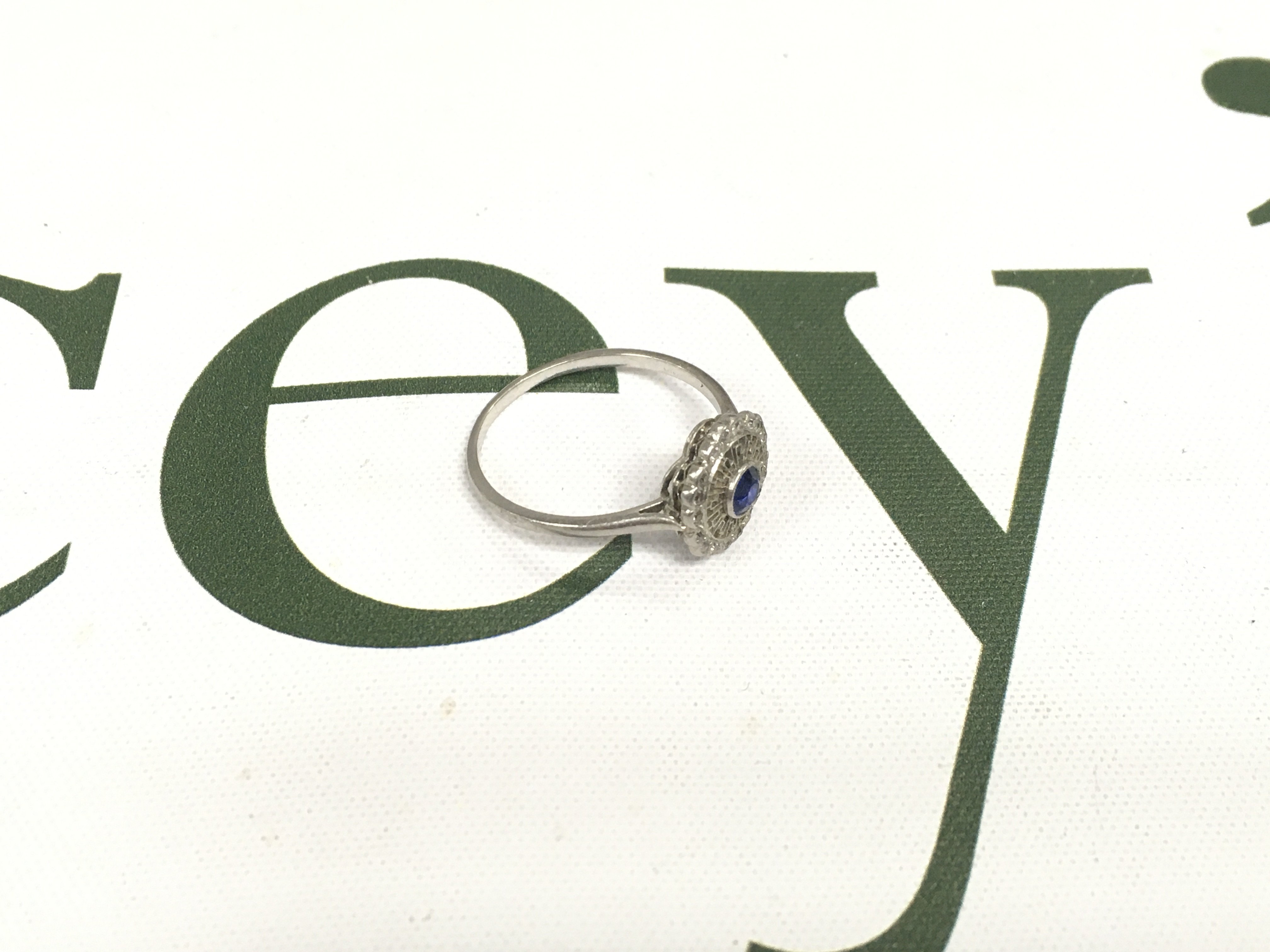 An unmarked white metal and sapphire ring. Approx size Q, approx weight 3.34 grams.