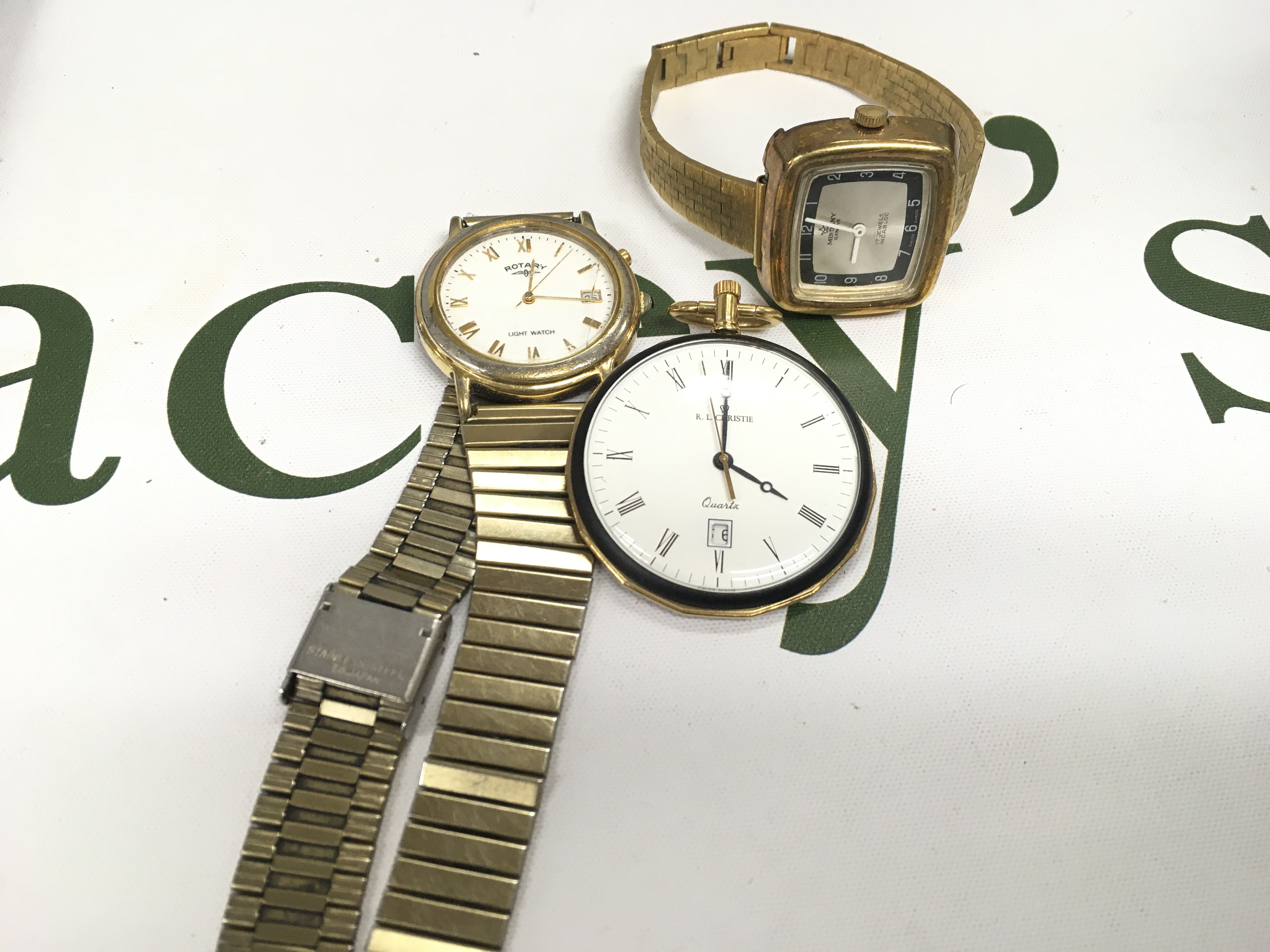 Two wrist watches and one fob watch.
