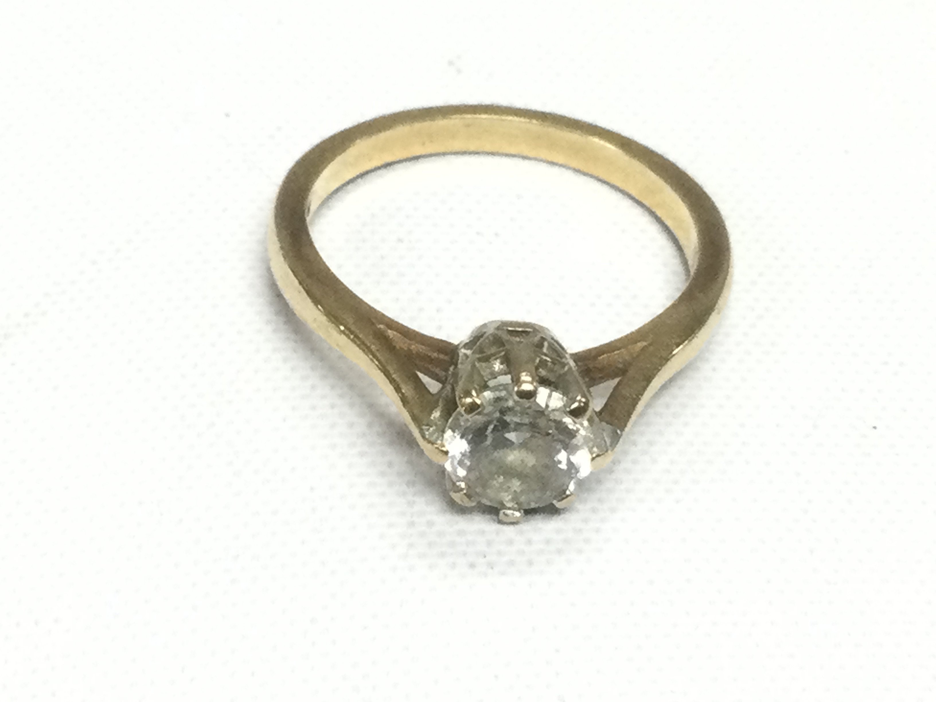 A 9ct gold and CZ solitaire ring, approx 3g and approx size N. Shipping category A.