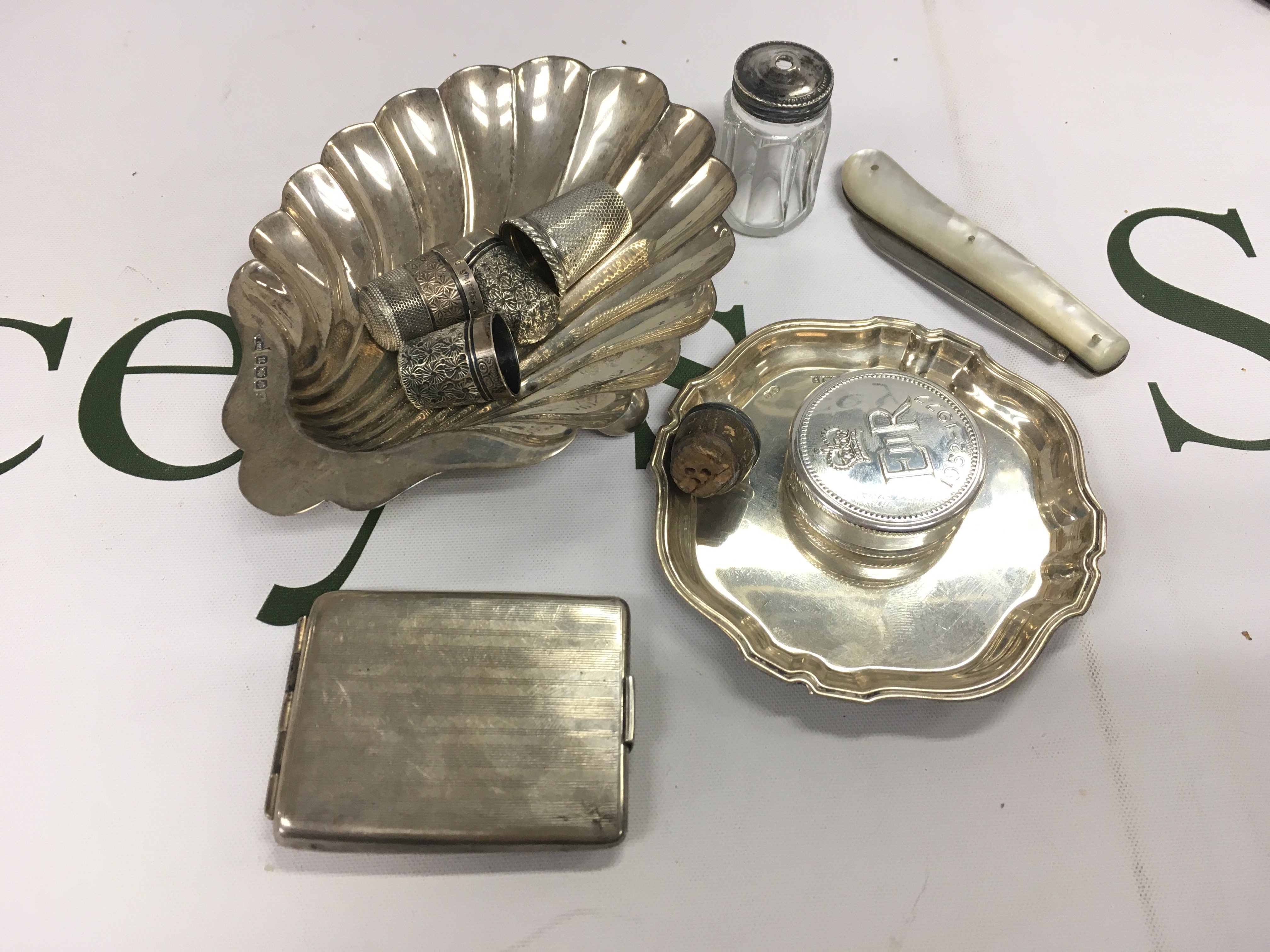 A mixed assortment of silver items.