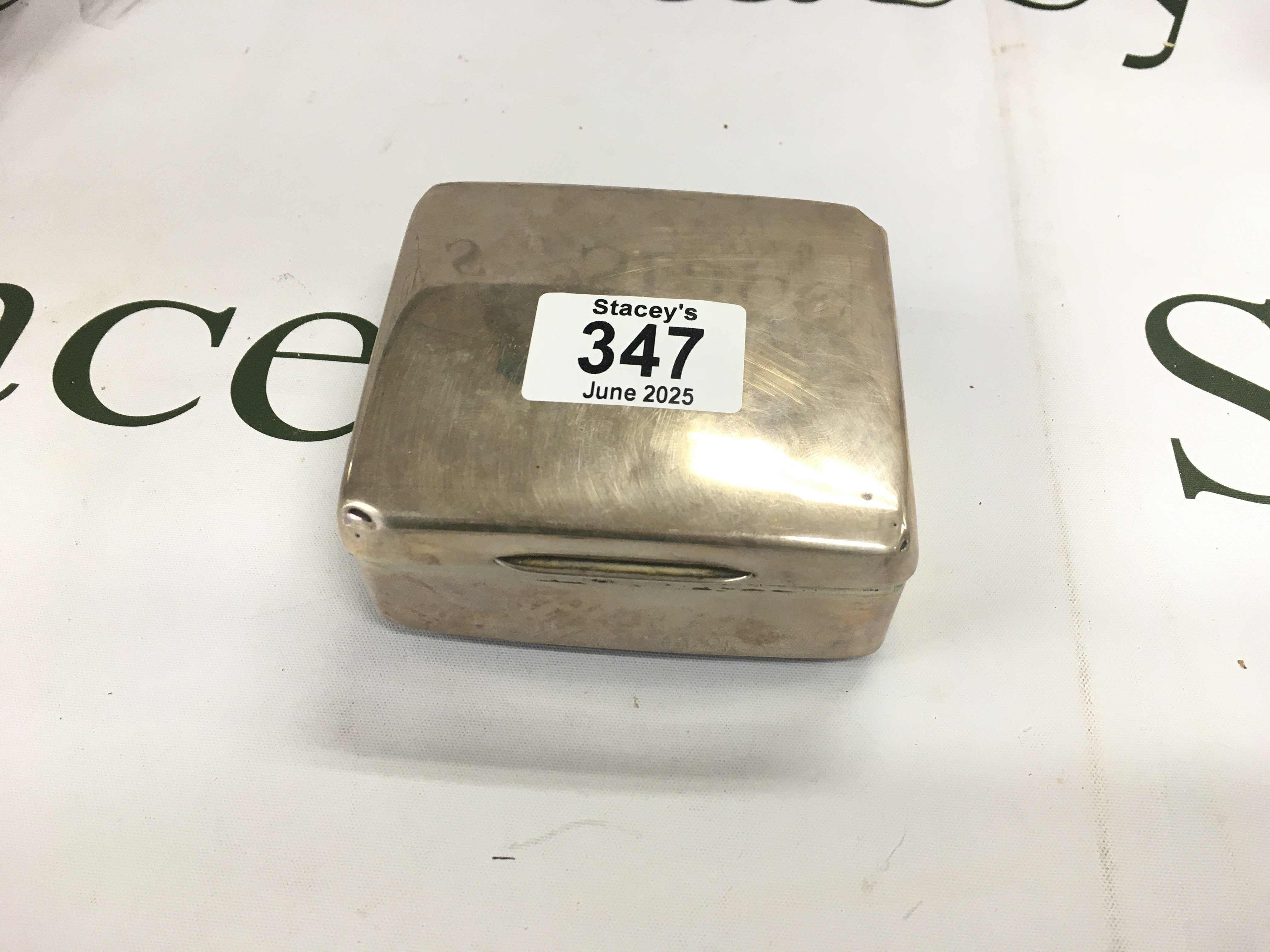 A silver box with leather bottom and wooden inside.