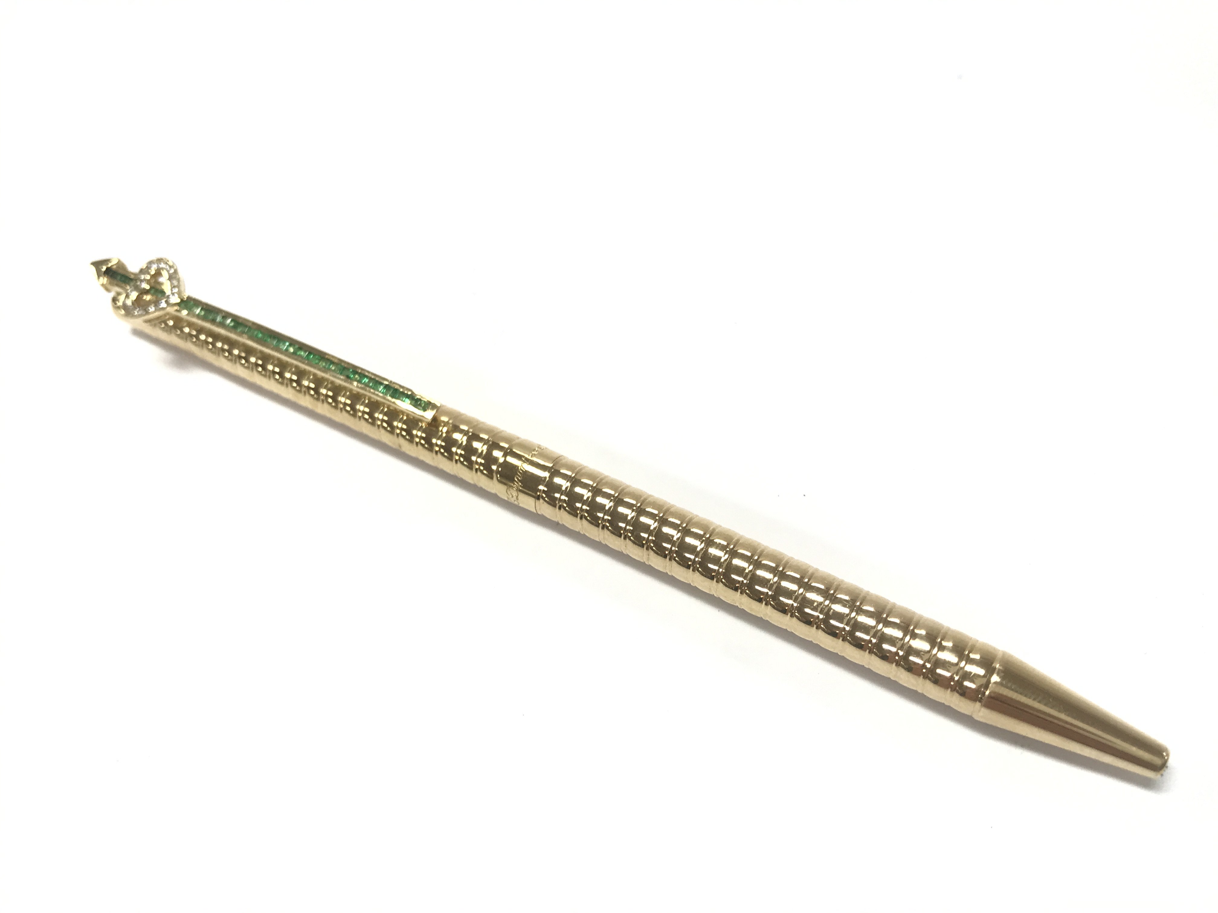 A S.T Dupont 14ct gold pen inset with diamonds and emerald stones. 27.6g total weight. Postage category A