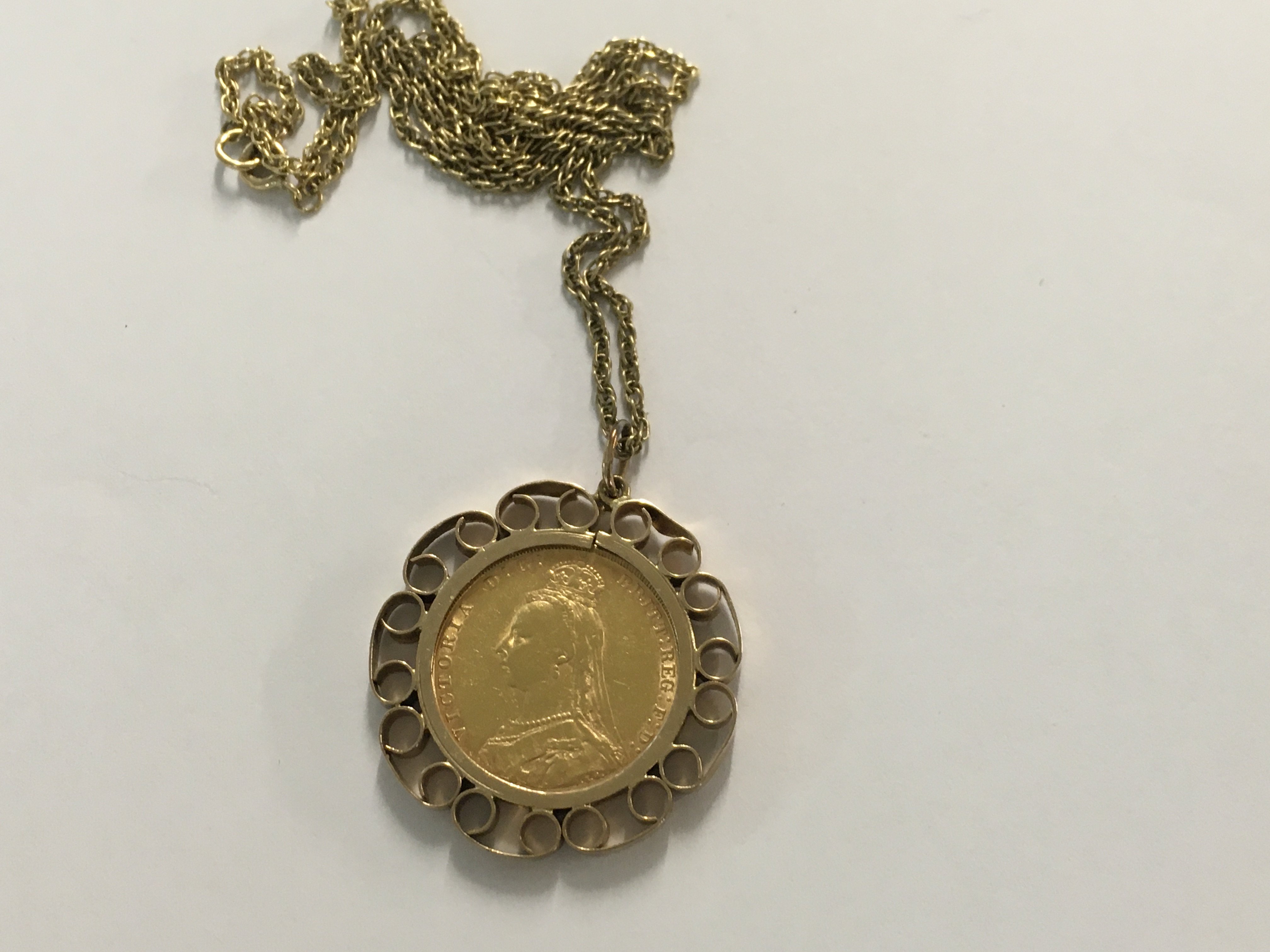 A gold victorian sovereign fitted in a mount with 9 ct gold chain total weight 14.88 grams.