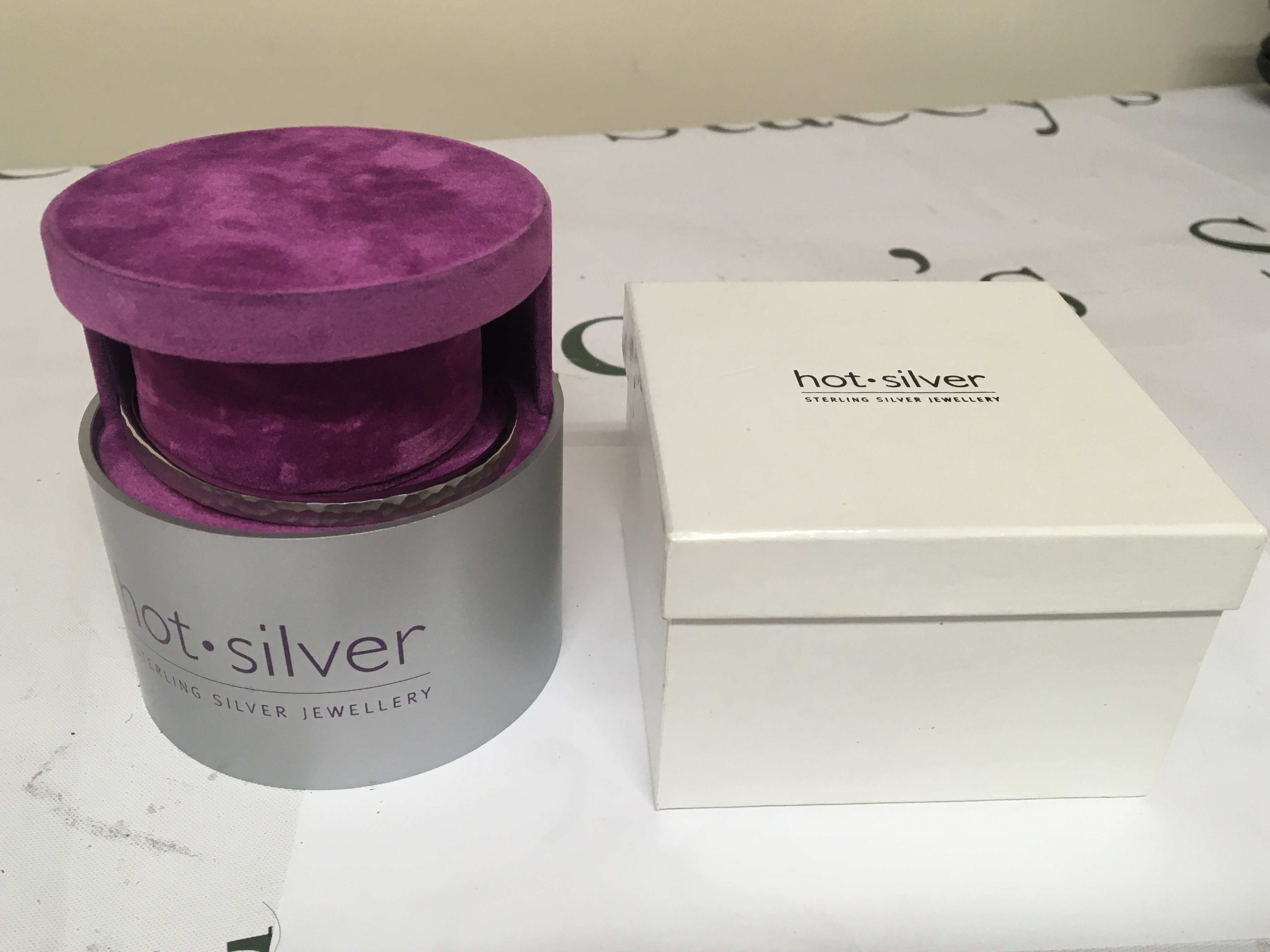 A modern design Hot Silver silver bangle bracelet with a patterned edge stamped 925. With inner display box and outer box.