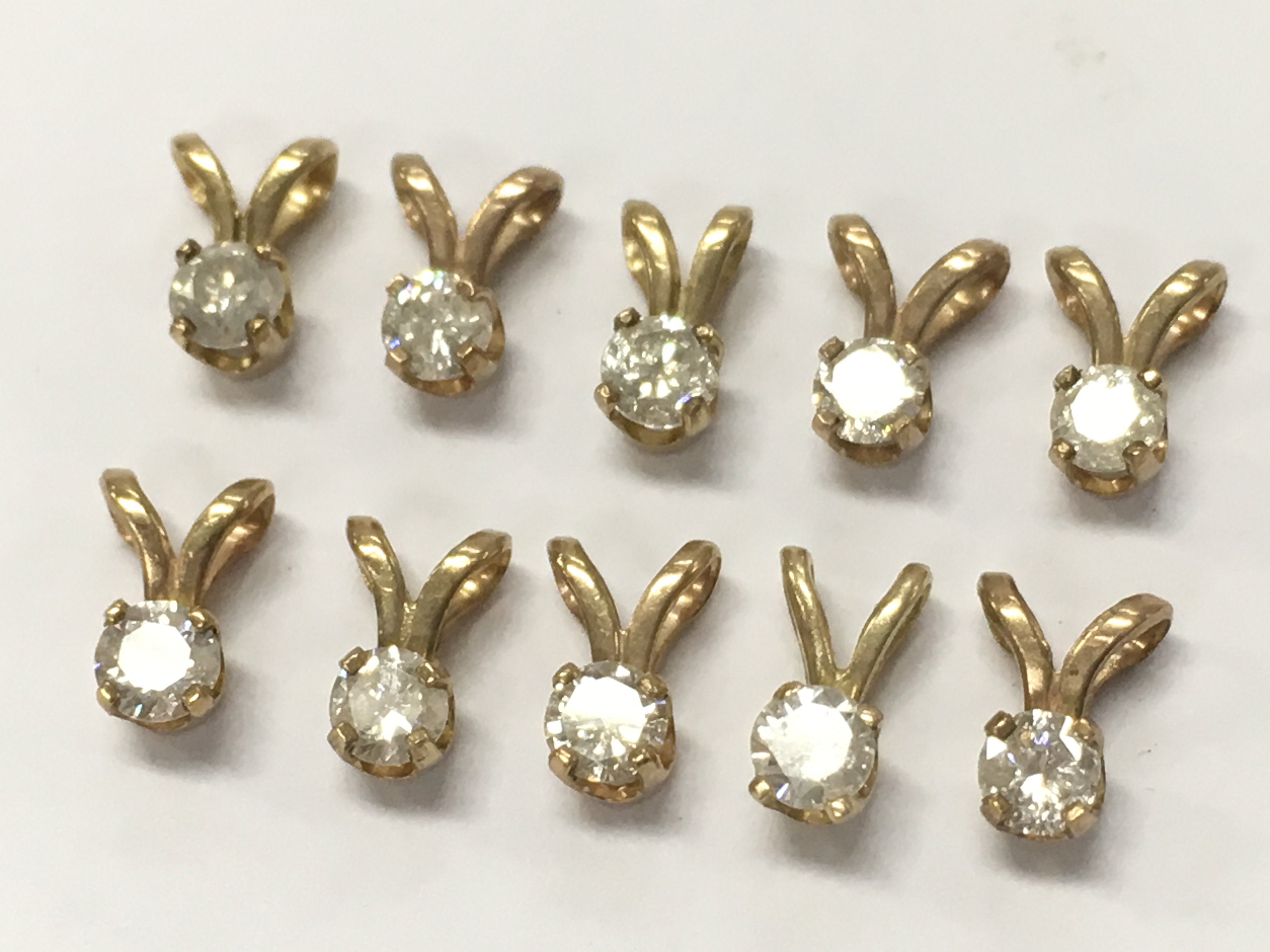 9ct Gold and diamond set pendants, 1.6g total weight. Postage category A