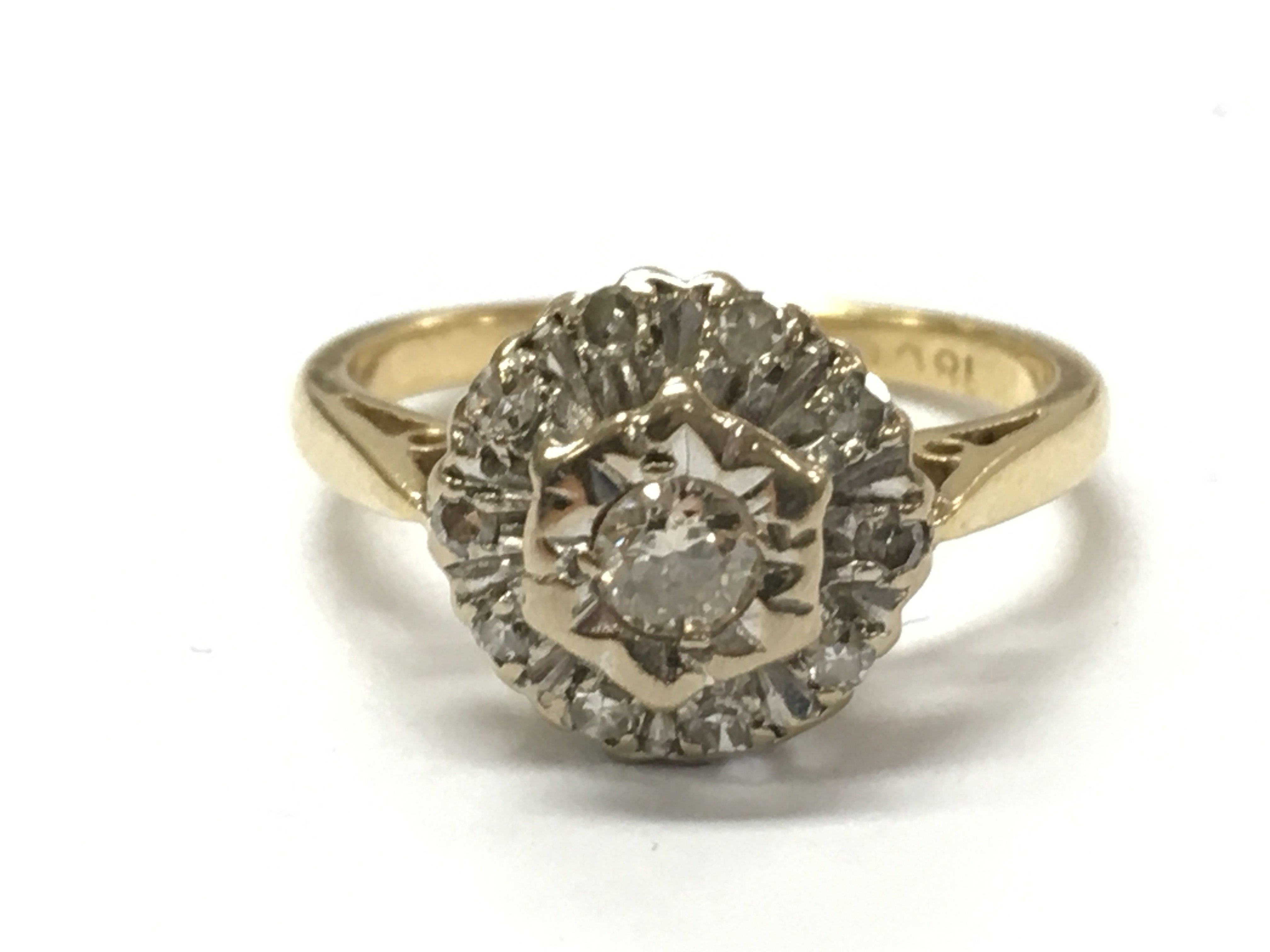 An 18ct gold diamond cluster ring, 3.3g total weight. Size I. Postage category A