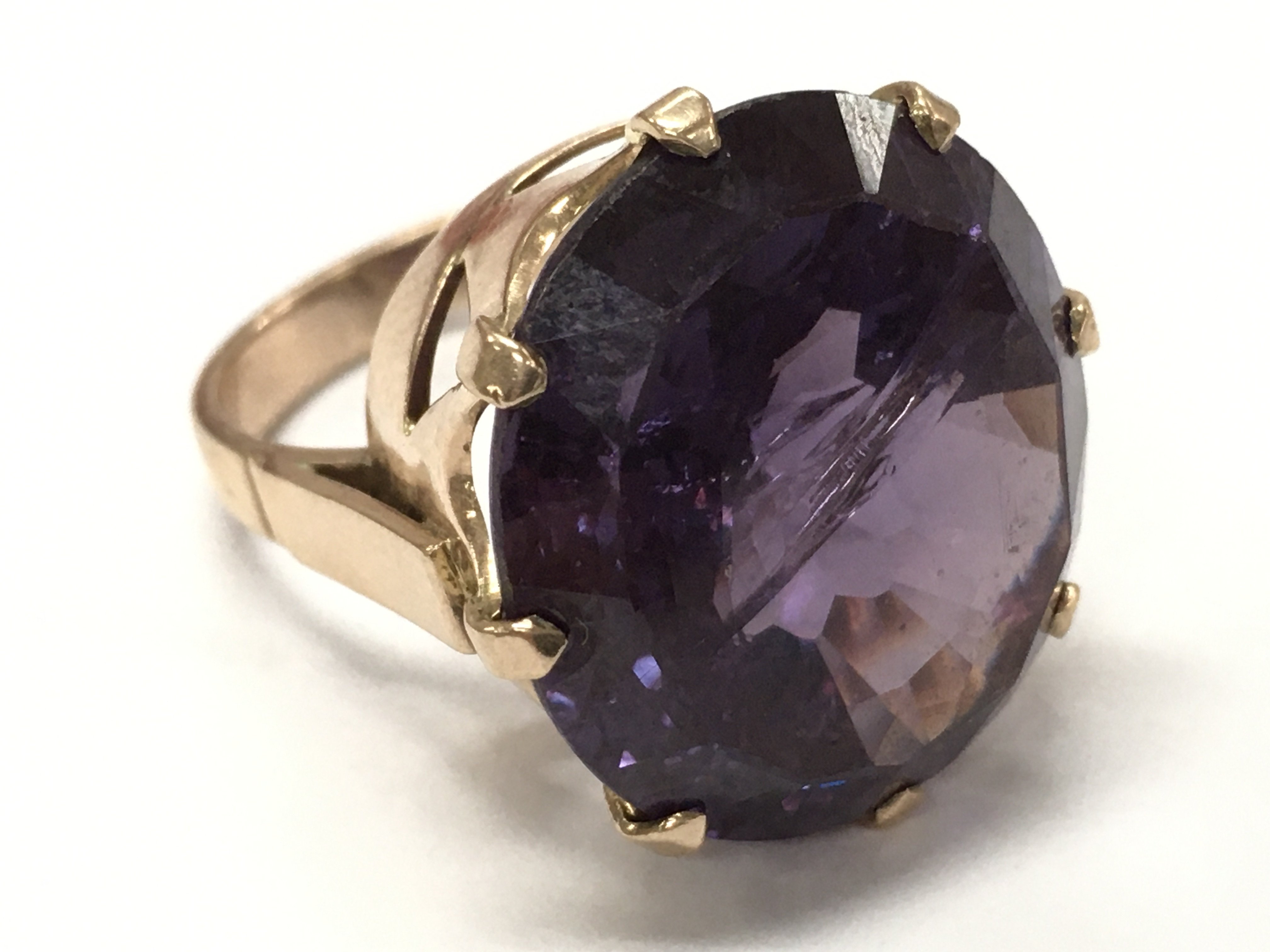 A purple cubic zirconia stone ring, size M. Postage catA