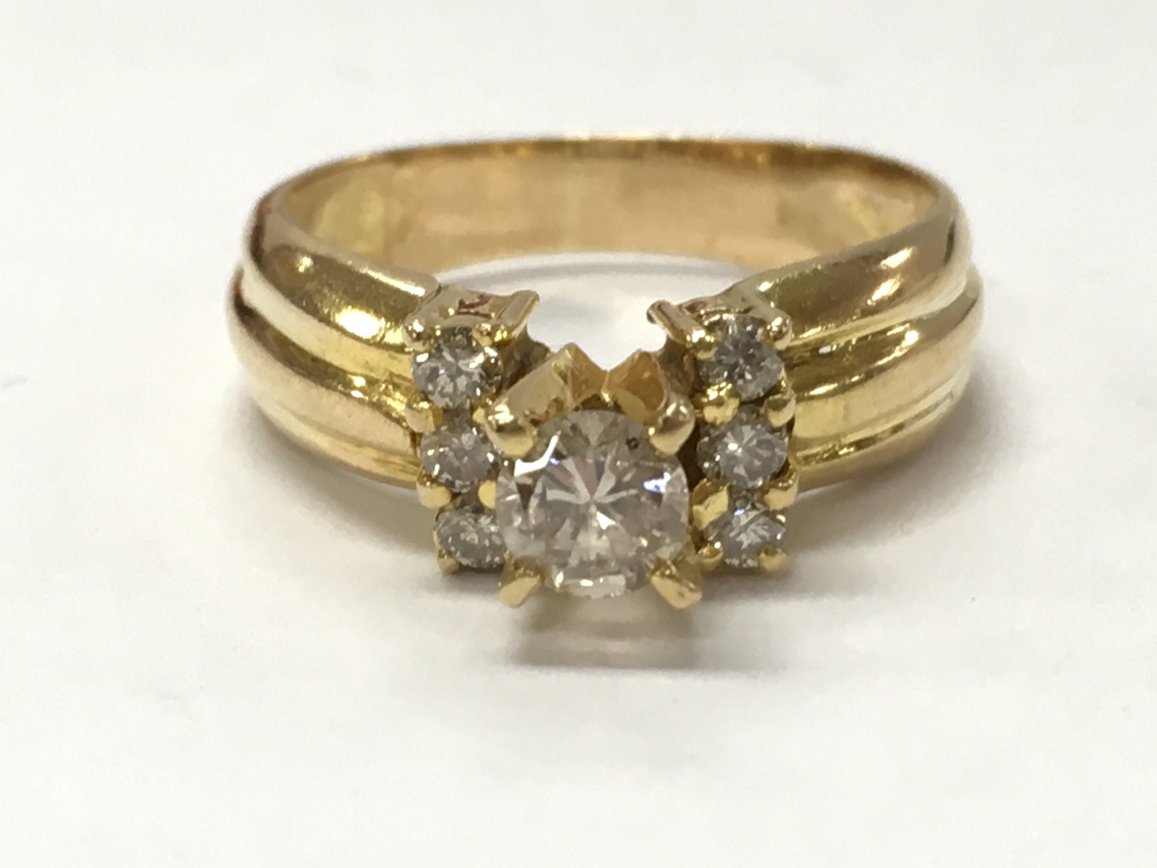 An unmarked 14ct gold diamond solitaire ring with diamond shoulders , size N. 4.5g total weight. Postage category A