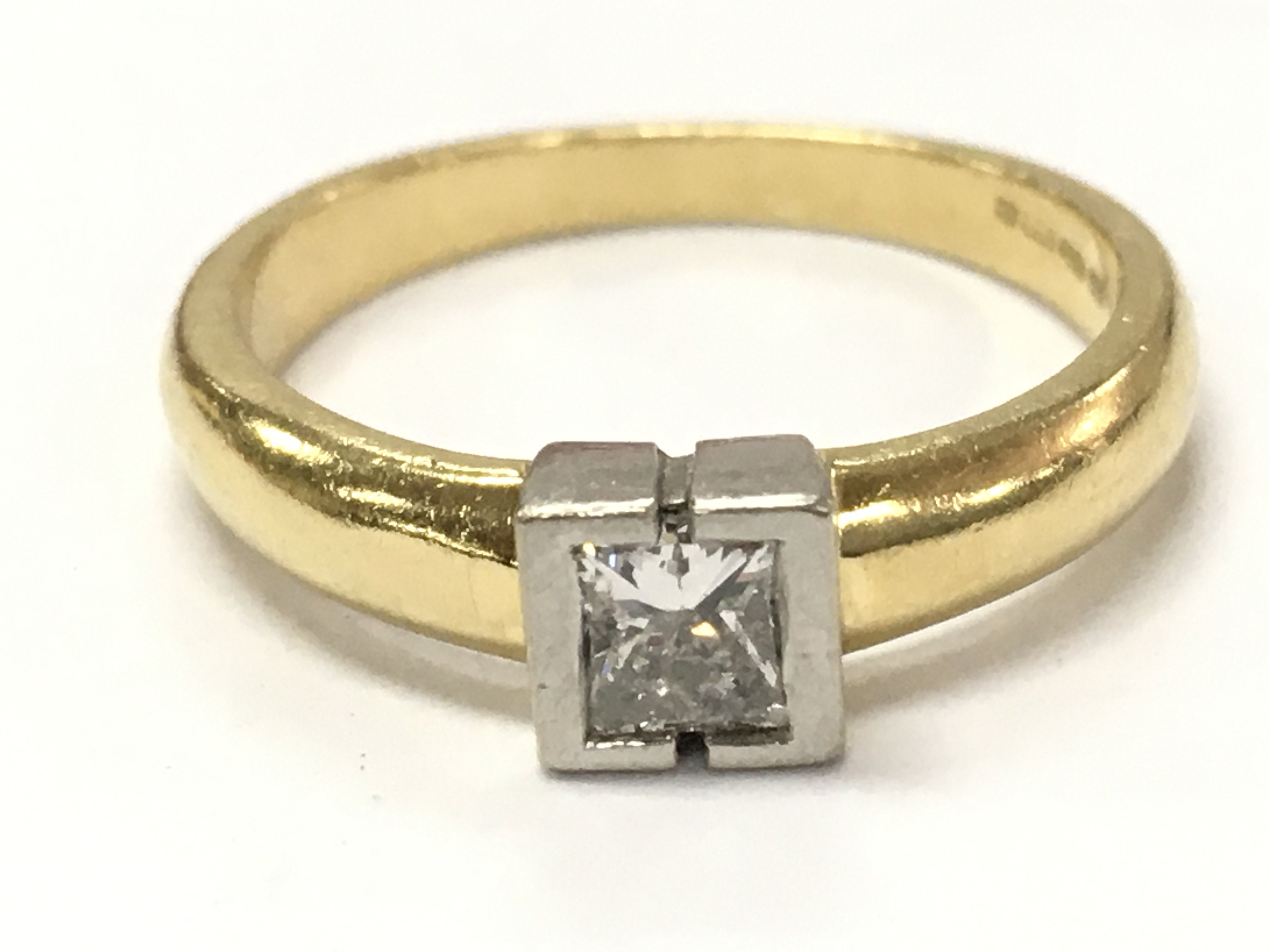 An 18ct gold princess cut diamond solitaire ring, 3.7g size L. Postage category A