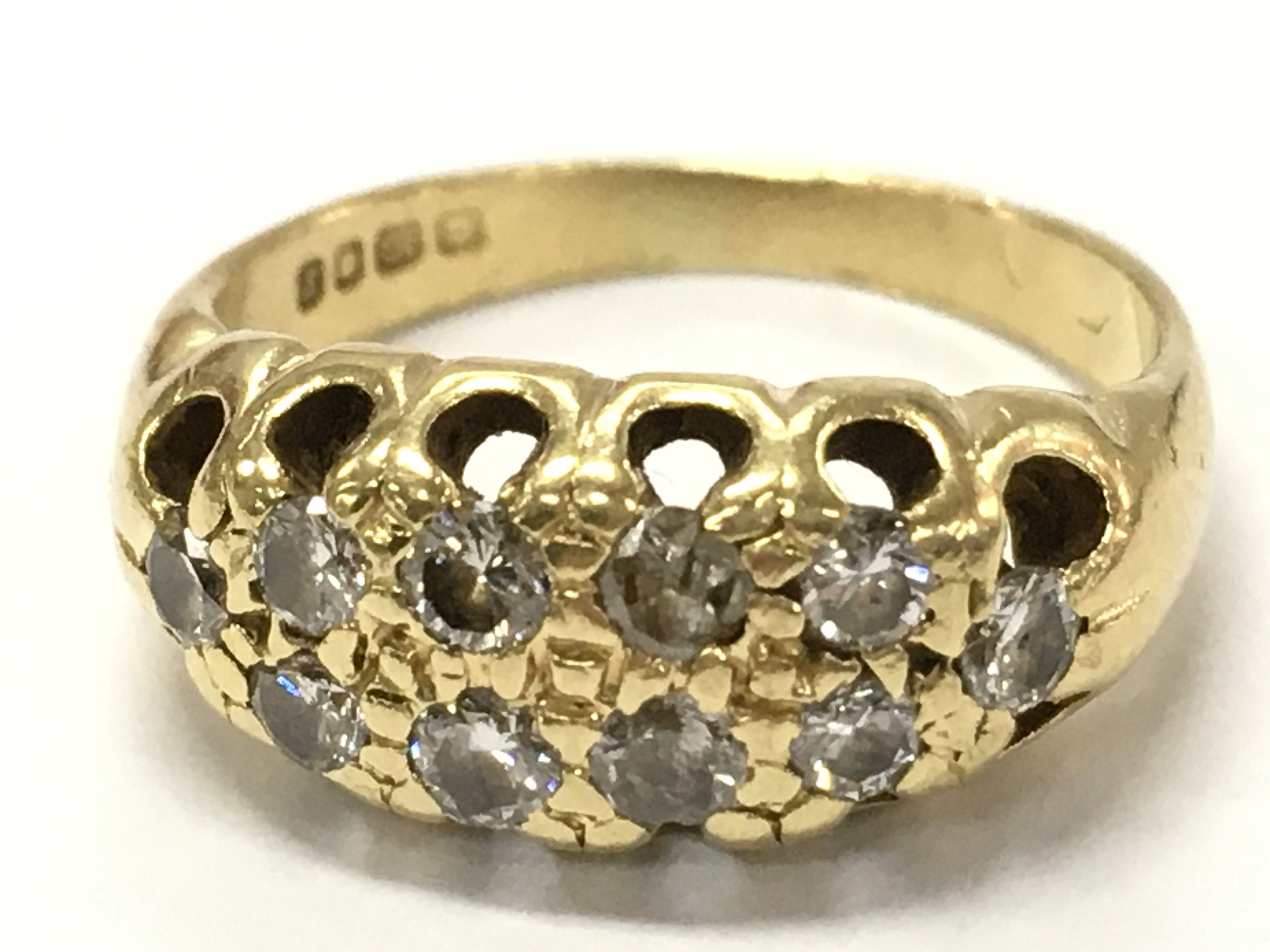 An 18ct gold diamond cluster ring, size H. 4g Postage cat a