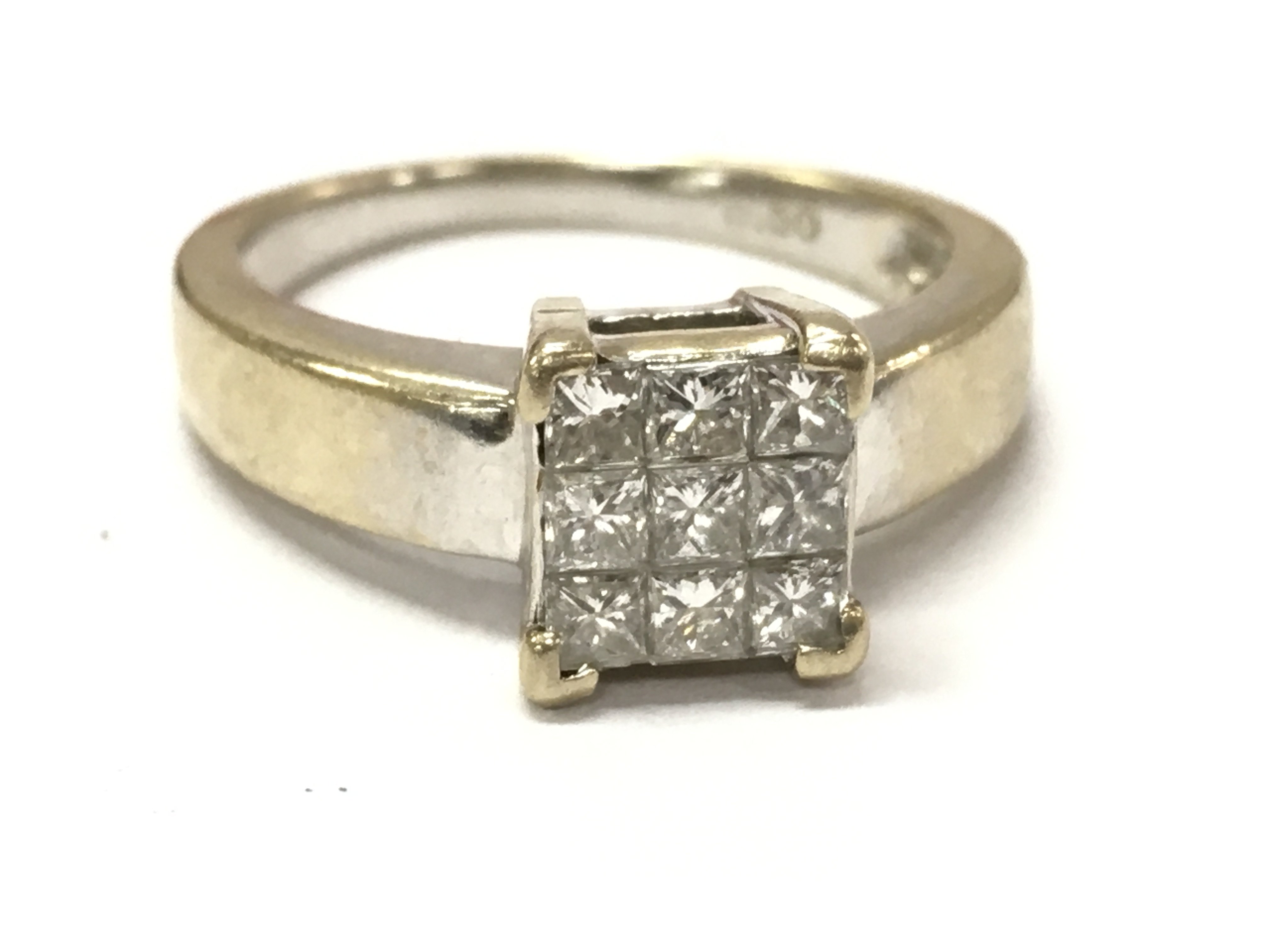 An 18ct white gold 9x princess cut diamond cluster ring. 4.6g L/M. Postage category A