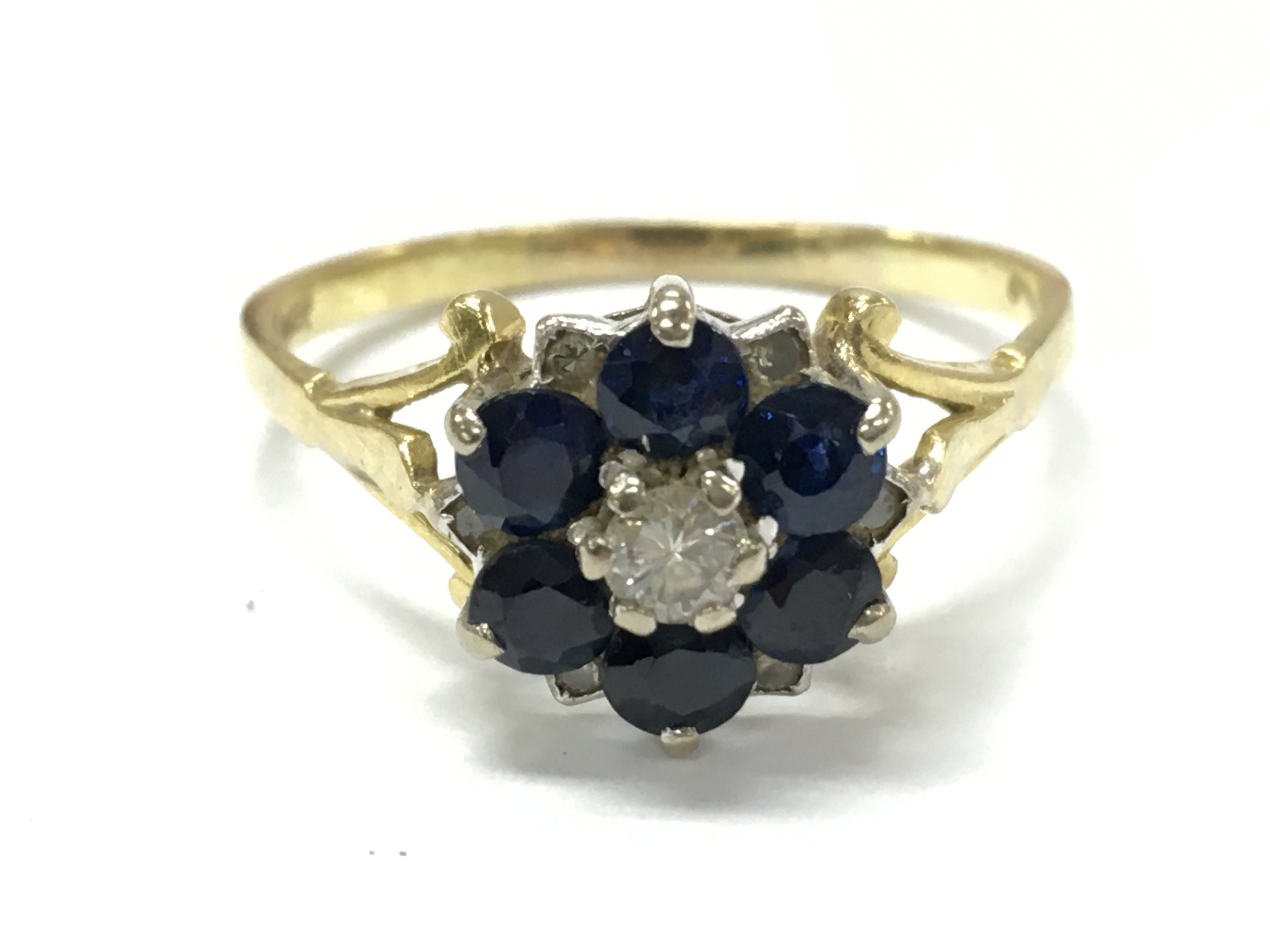 An 18ct gold sapphire/ diamond cluster ring , 3.9g total weight . Postage category A