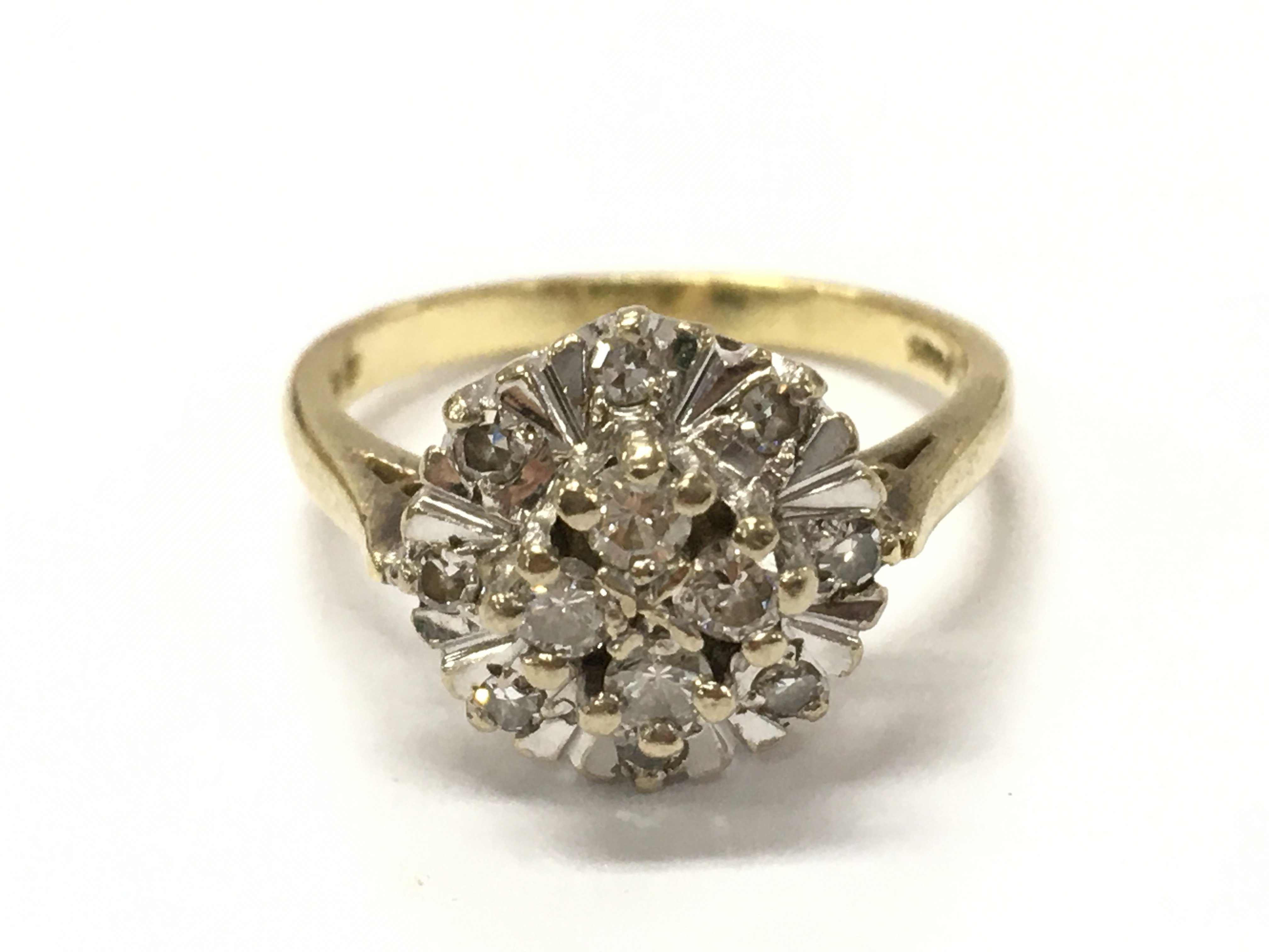 An 18ct gold diamond cluster ring. 4.6g total weight K/L. Postage category A