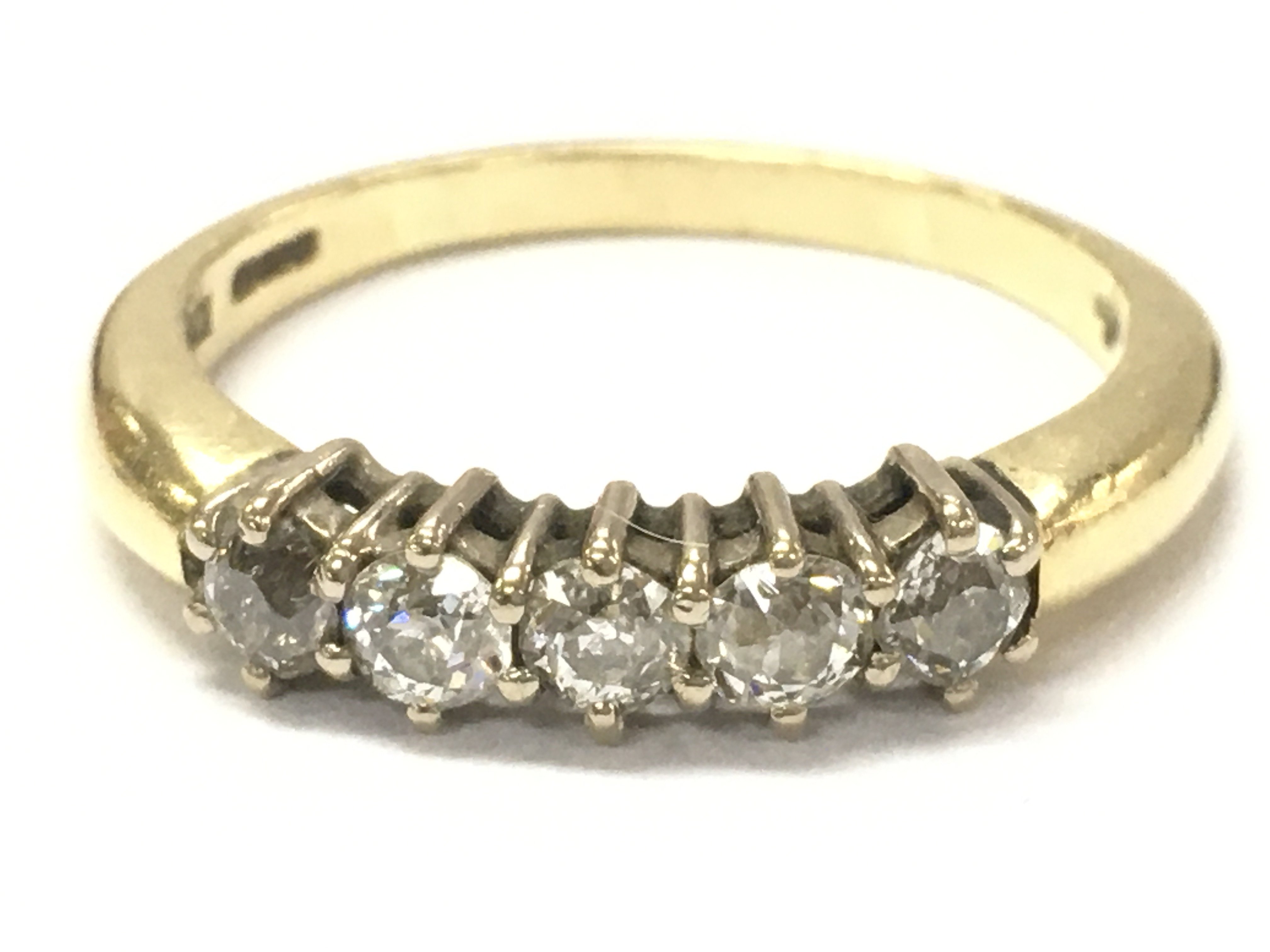An 18ct gold 5 stone diamond ring , size U, 5.3g . Postage category A