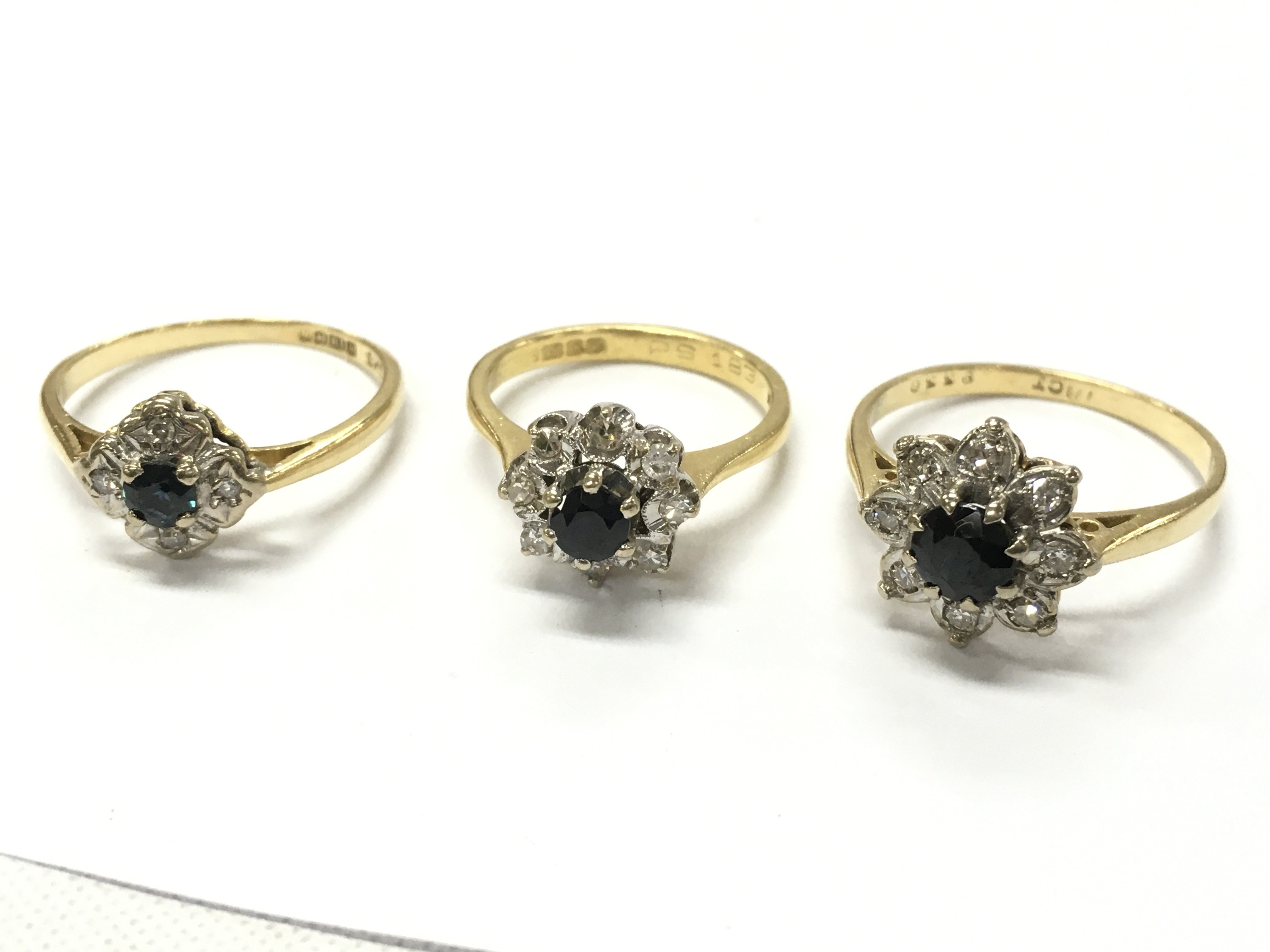 18ct gold sapphire and diamond set cluster ring , 10.7g total weight . Postage category A