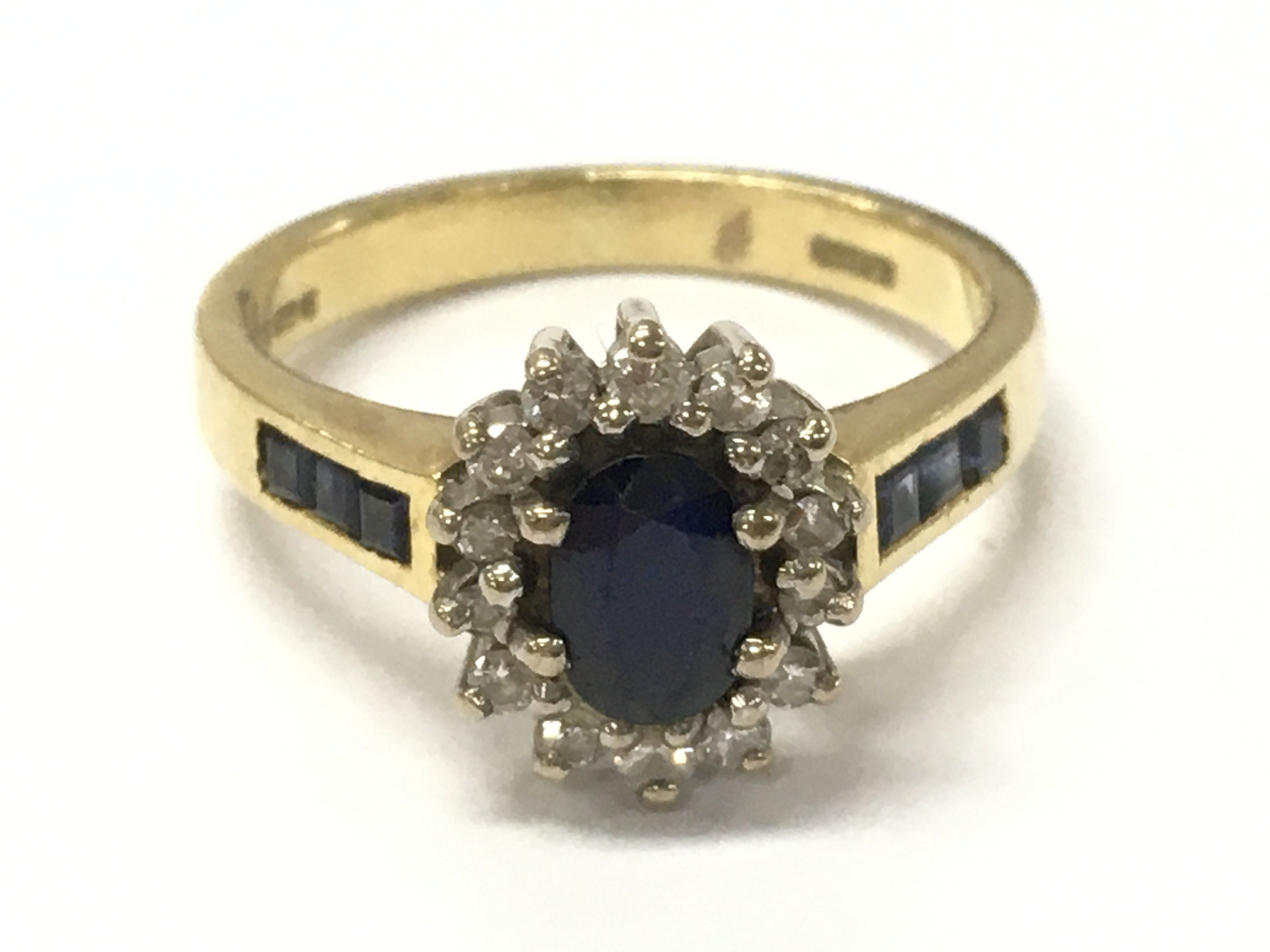 An 18ct gold sapphire and diamond cluster ring, size K/L. 4.2g postage category A