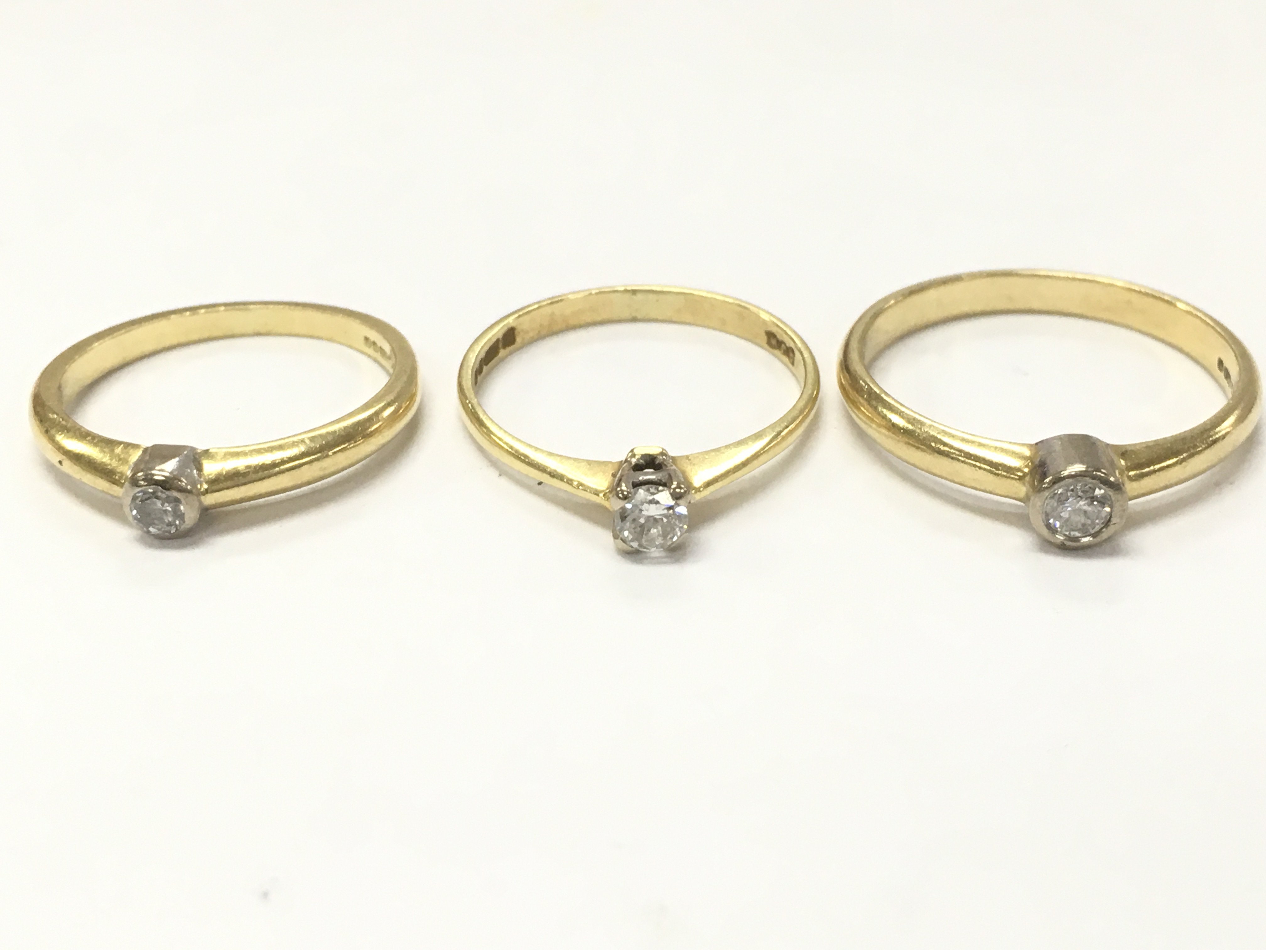 18ct gold diamond solitaire rings , sizes P, L, K. 7g total weight. postage category A