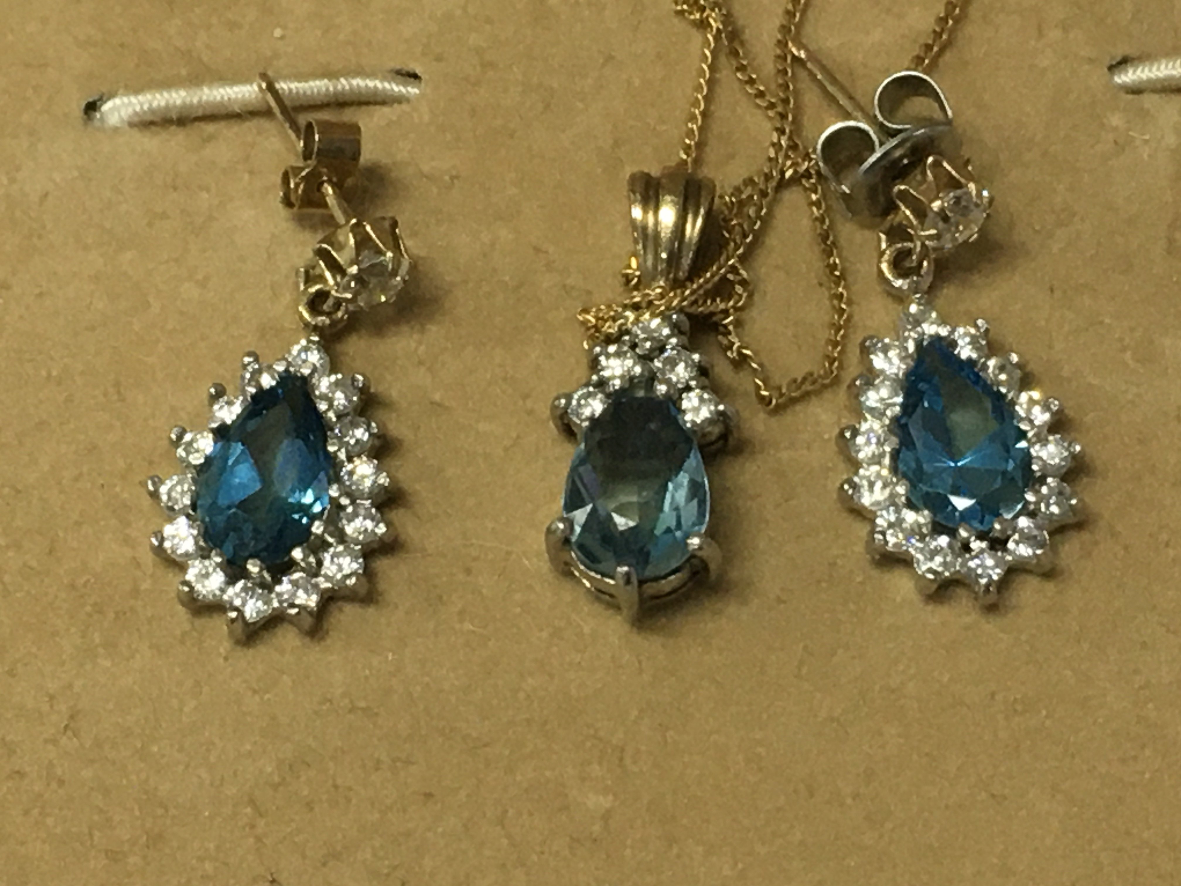 A aquarium pear shaped pendant with diamonds mounted on a 9ct gold chain with a matching Pair of earrings.