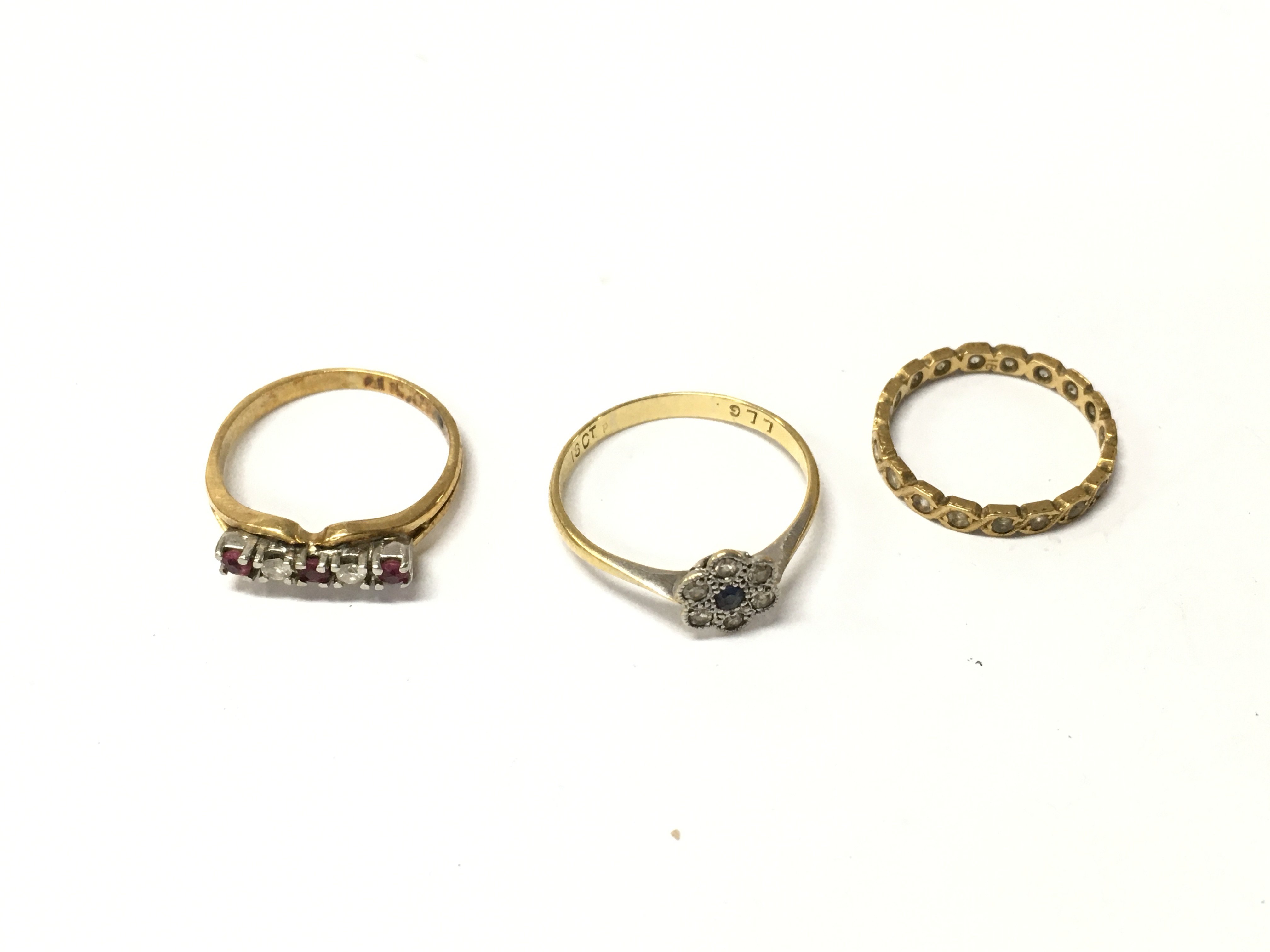 Three 18ct marks rings set with stones. Approx weight 6.82 grams.