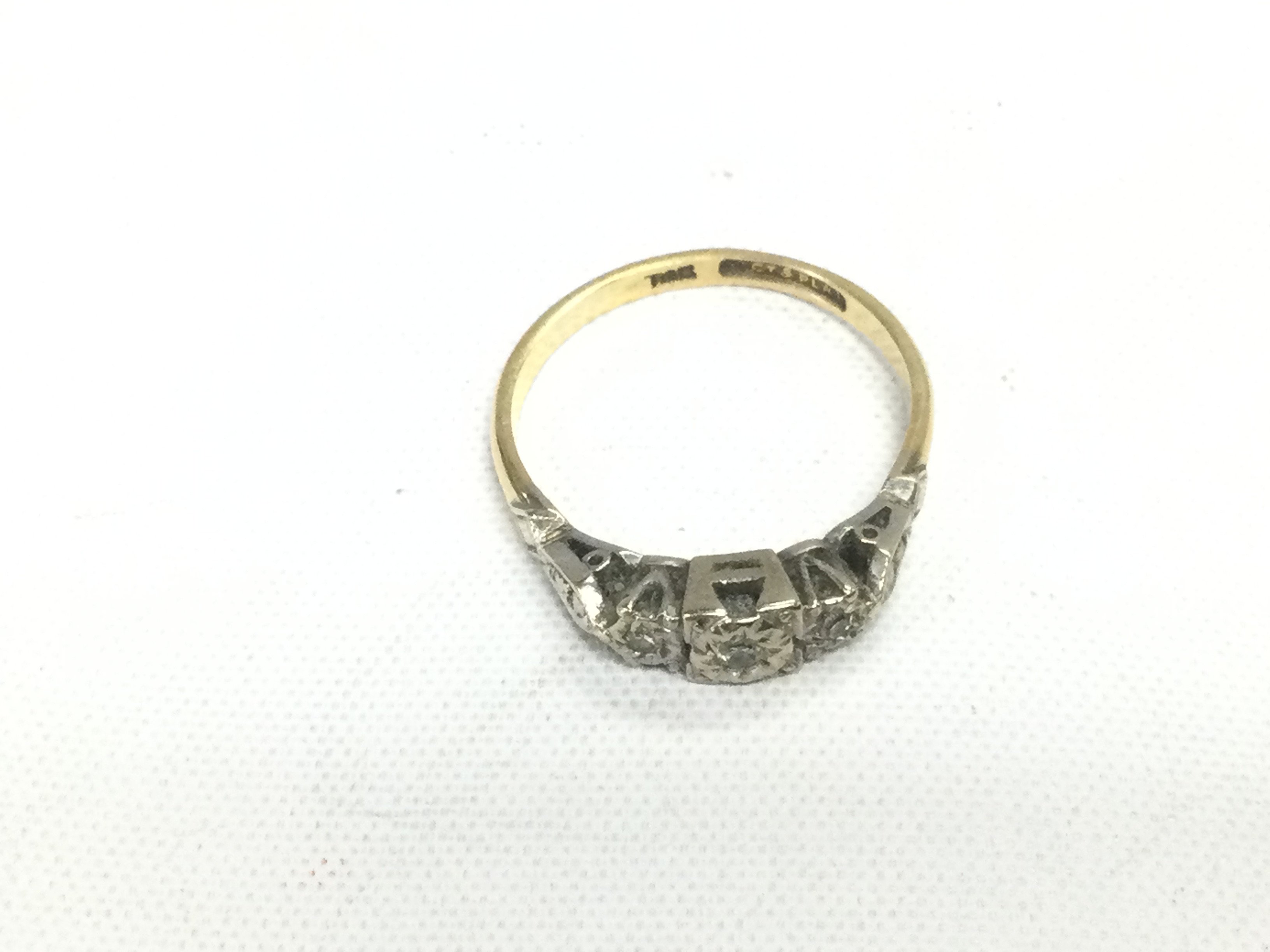 An 18ct gold and platinum ring set with small diamonds, approx 2.9g and approx size O. Shipping category A.